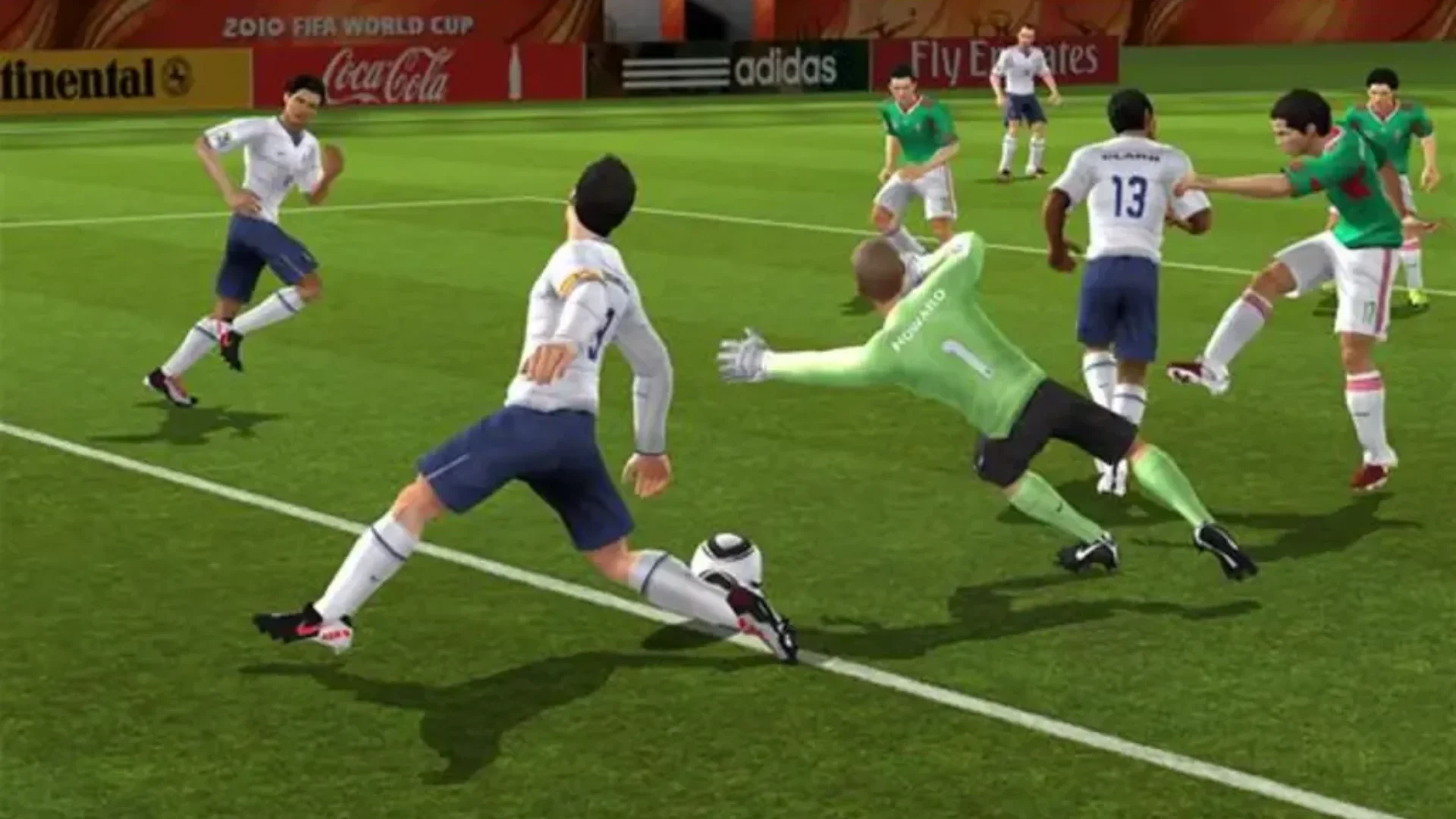 2010 FIFA World Cup South Africa gameplay showing a goalkeeper diving as players contest the ball near goal.