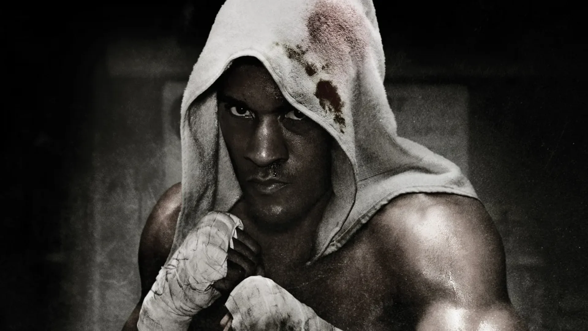 Andre Bishop stands with wrapped hands and a towel over his head in black-and-white Fight Night Champion artwork.