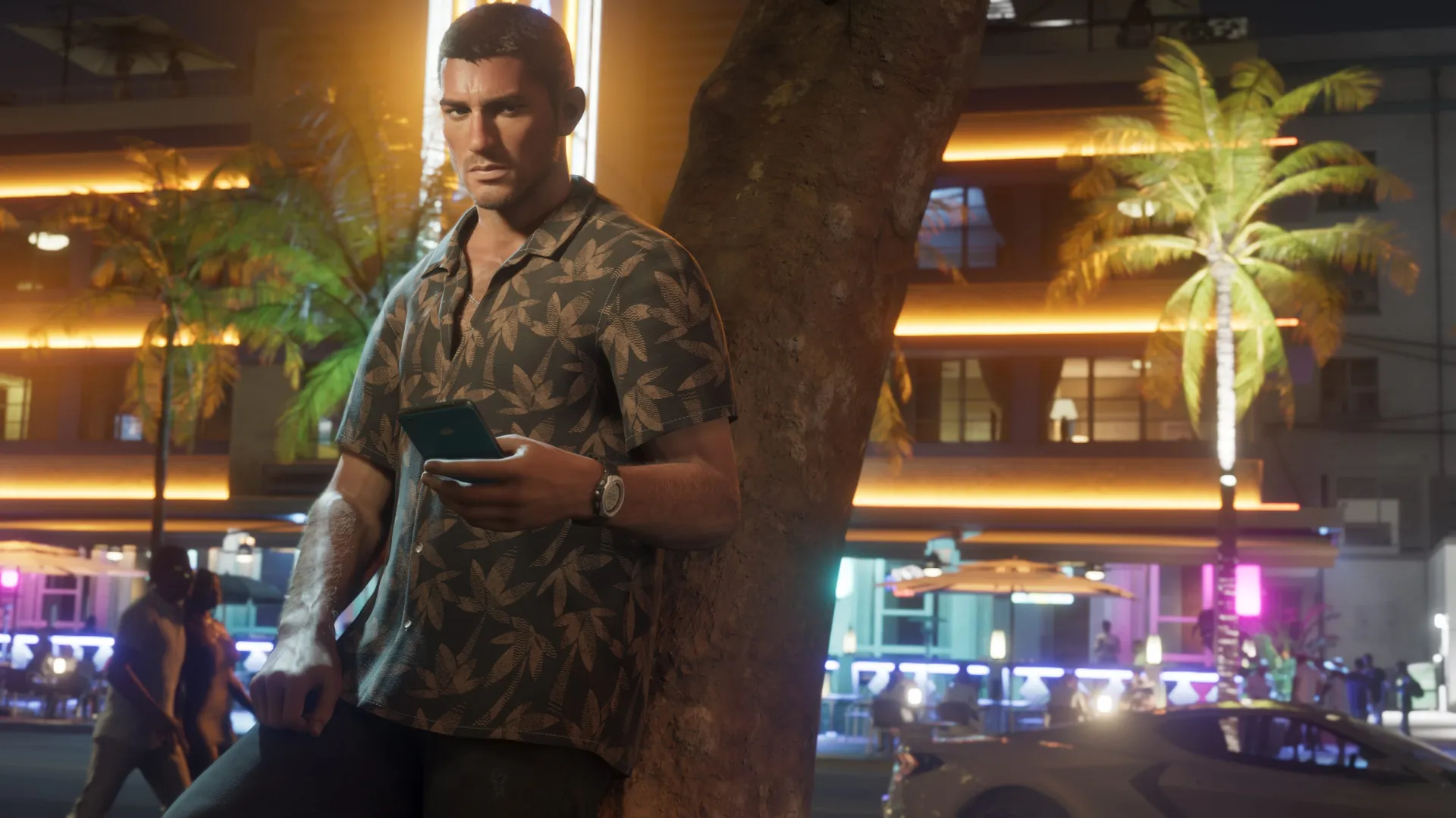 Jason stands by a palm tree while holding a phone in Grand Theft Auto VI.