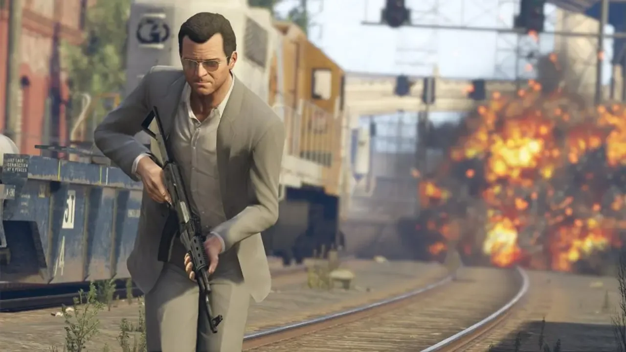Michael De Santa running with an assault rifle as a train passes and an explosion erupts behind him in Grand Theft Auto V