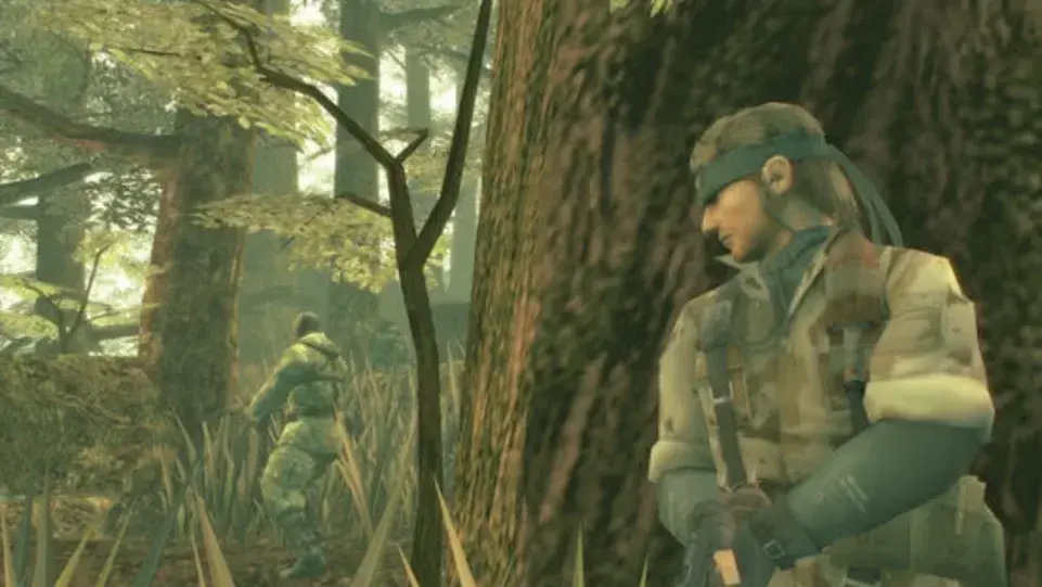 Naked Snake hides behind a tree while stalking an enemy soldier in Metal Gear Solid 3: Snake Eater.