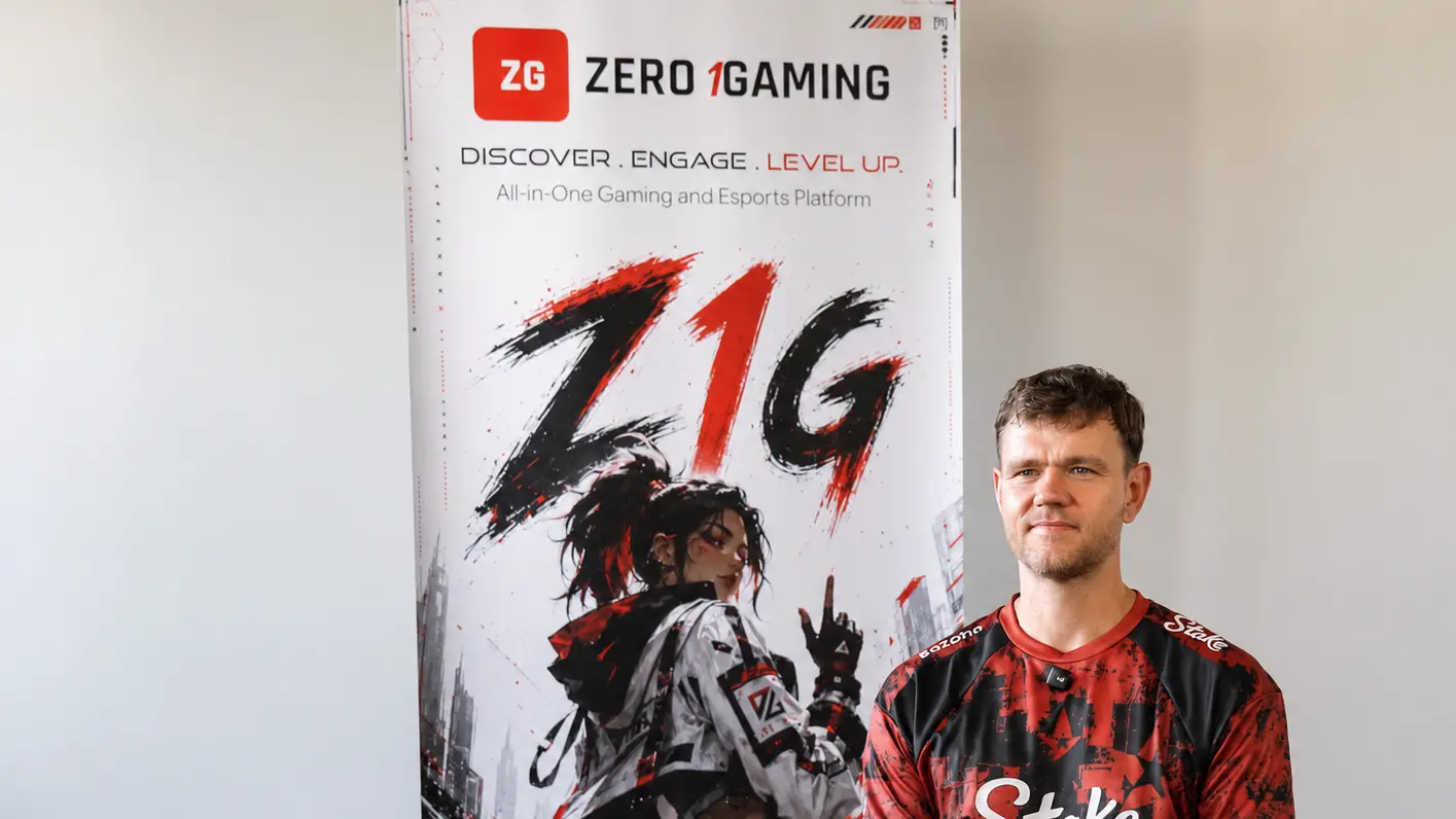 Filip “NEO” Kubski wearing an Astralis jersey while sitting beside a Zero1Gaming banner during an interview.