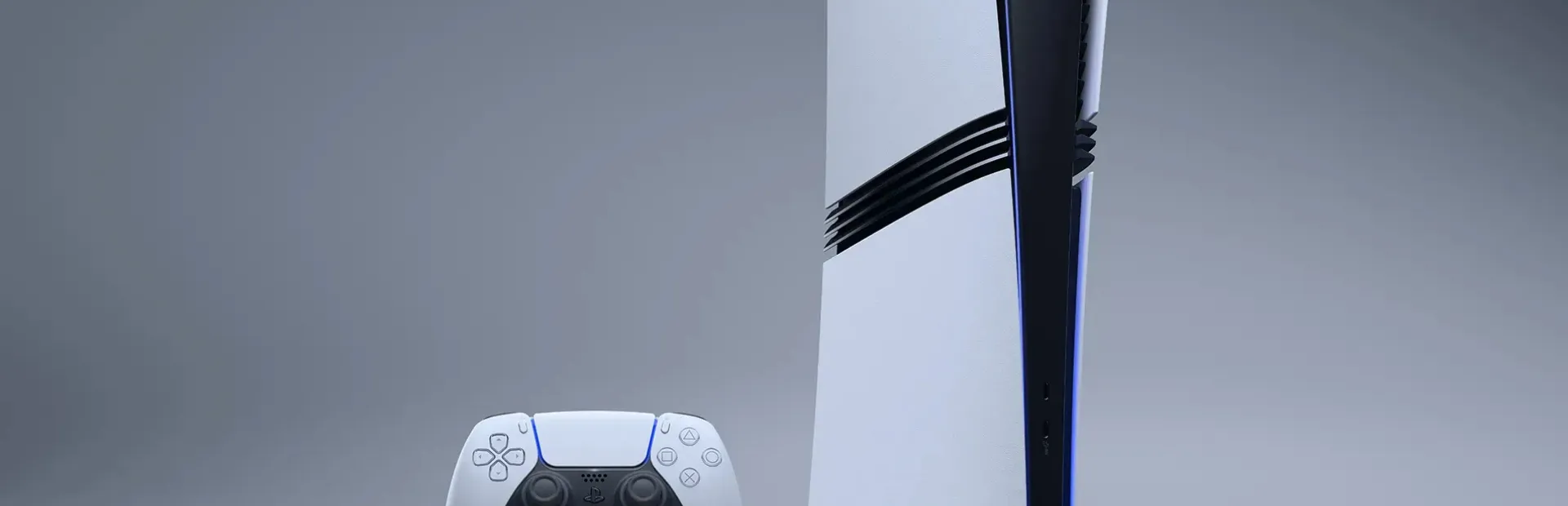 A white PlayStation 5 console stands upright beside a white DualSense controller against a plain grey background.