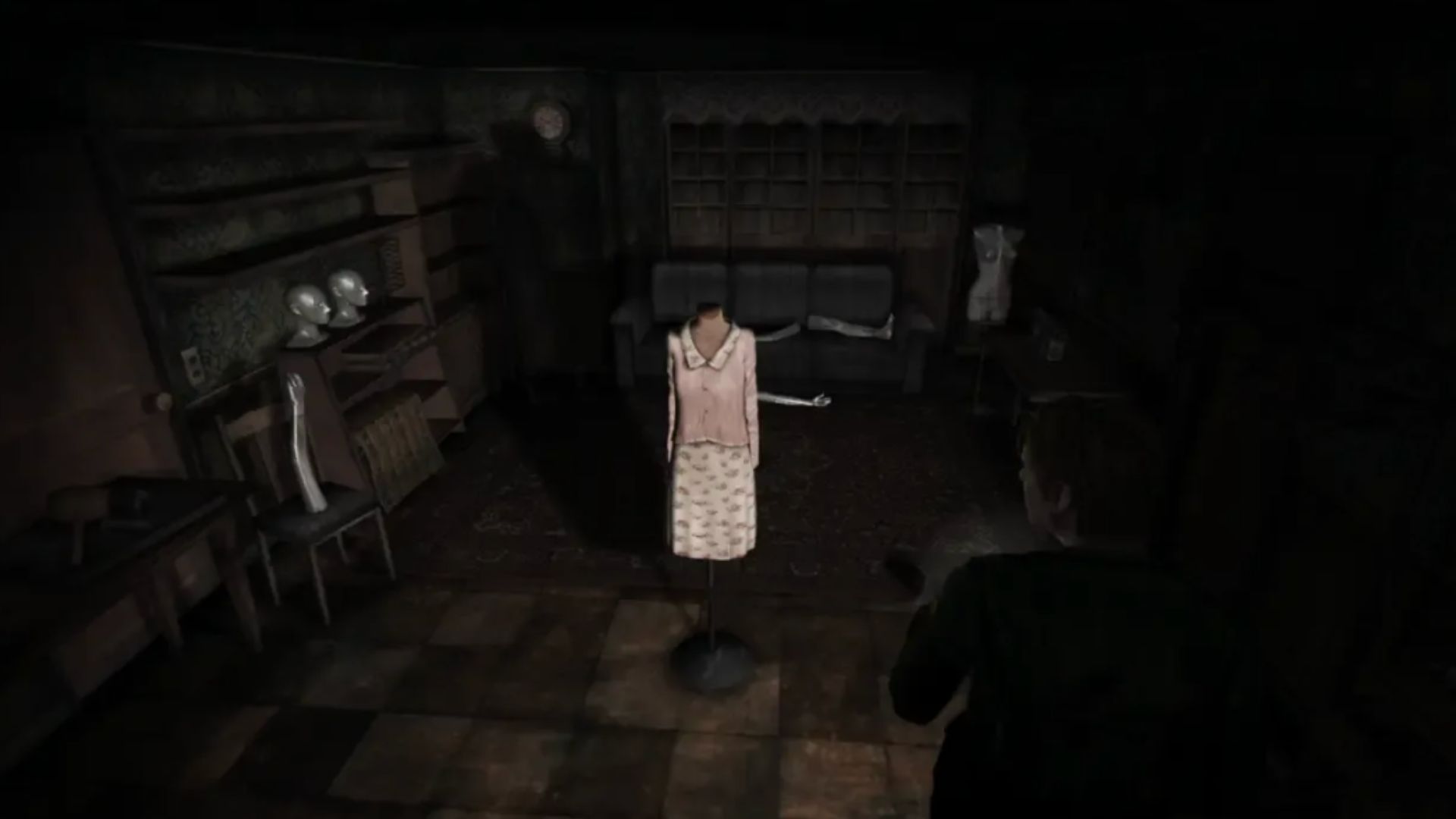 screenshot from silent hill 2 showing a headless mannequin doll in a dark room