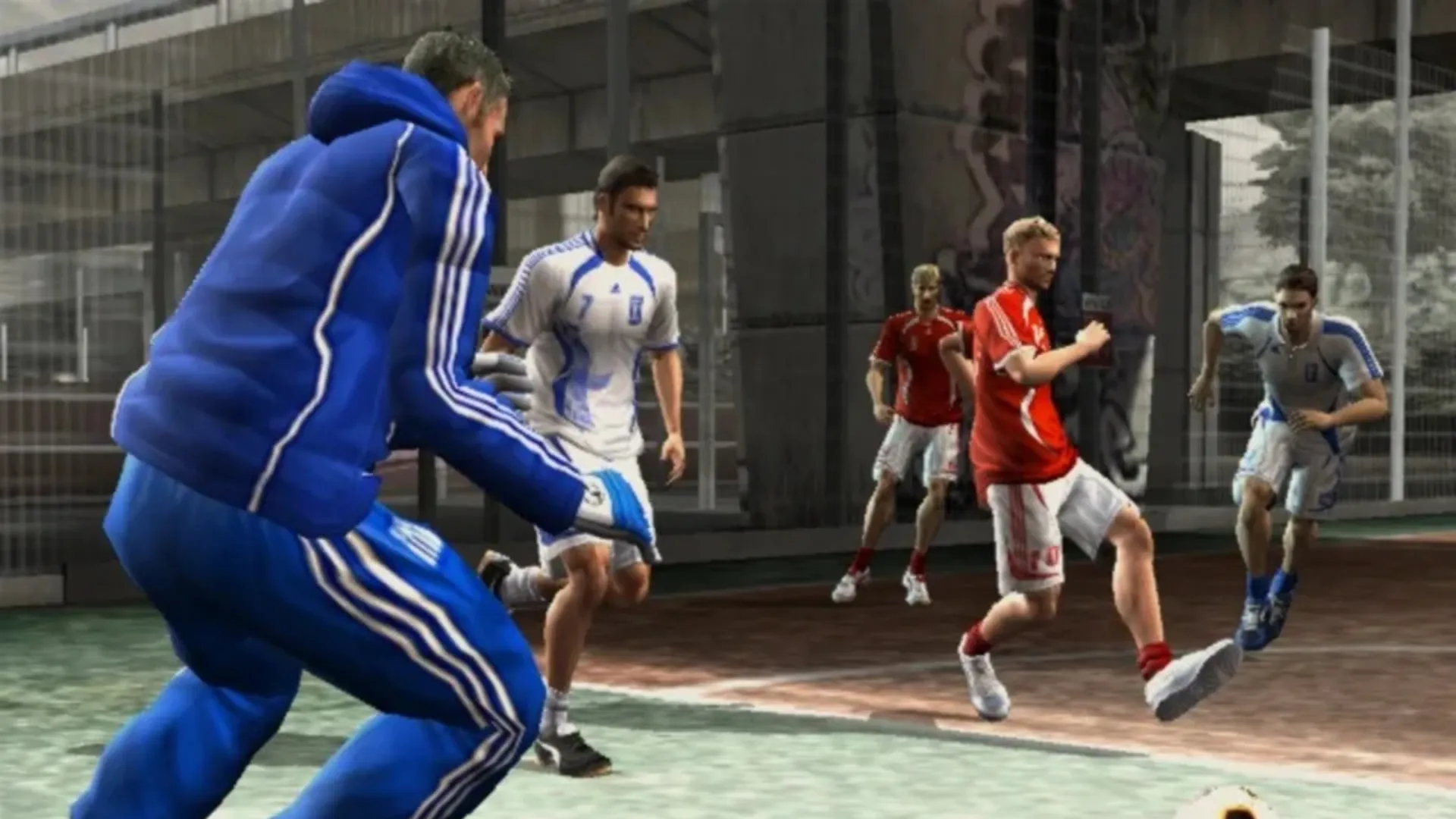 Players in Greece and Denmark kits chase the ball on a caged concrete court beneath a graffitied flyover in FIFA Street 2.