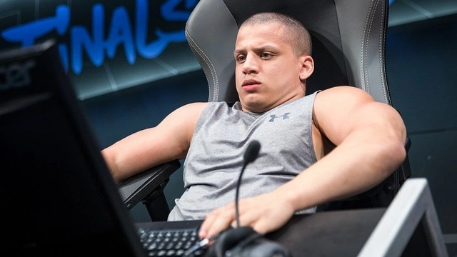 Tyler1 playing League of Legends onstage during an esports event.