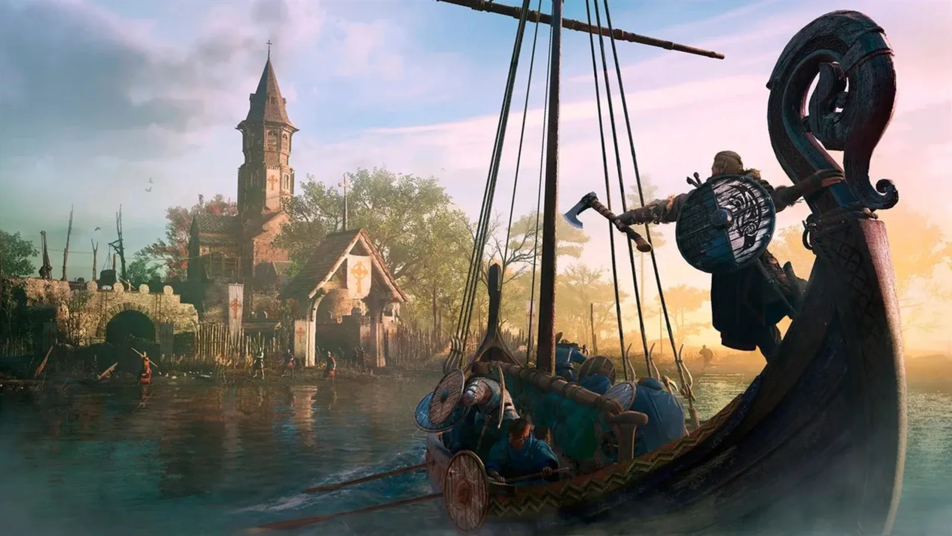 A Viking stands on the prow of a longship full of raiders approaching a riverside monastery at dawn in Assassin's Creed Valhalla.