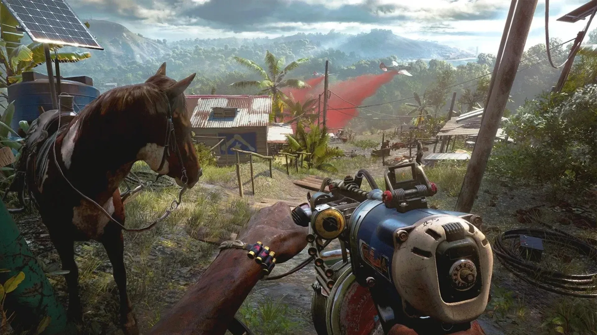A first-person view holding a scrap-built weapon beside a horse overlooking a jungle village in Far Cry 6.