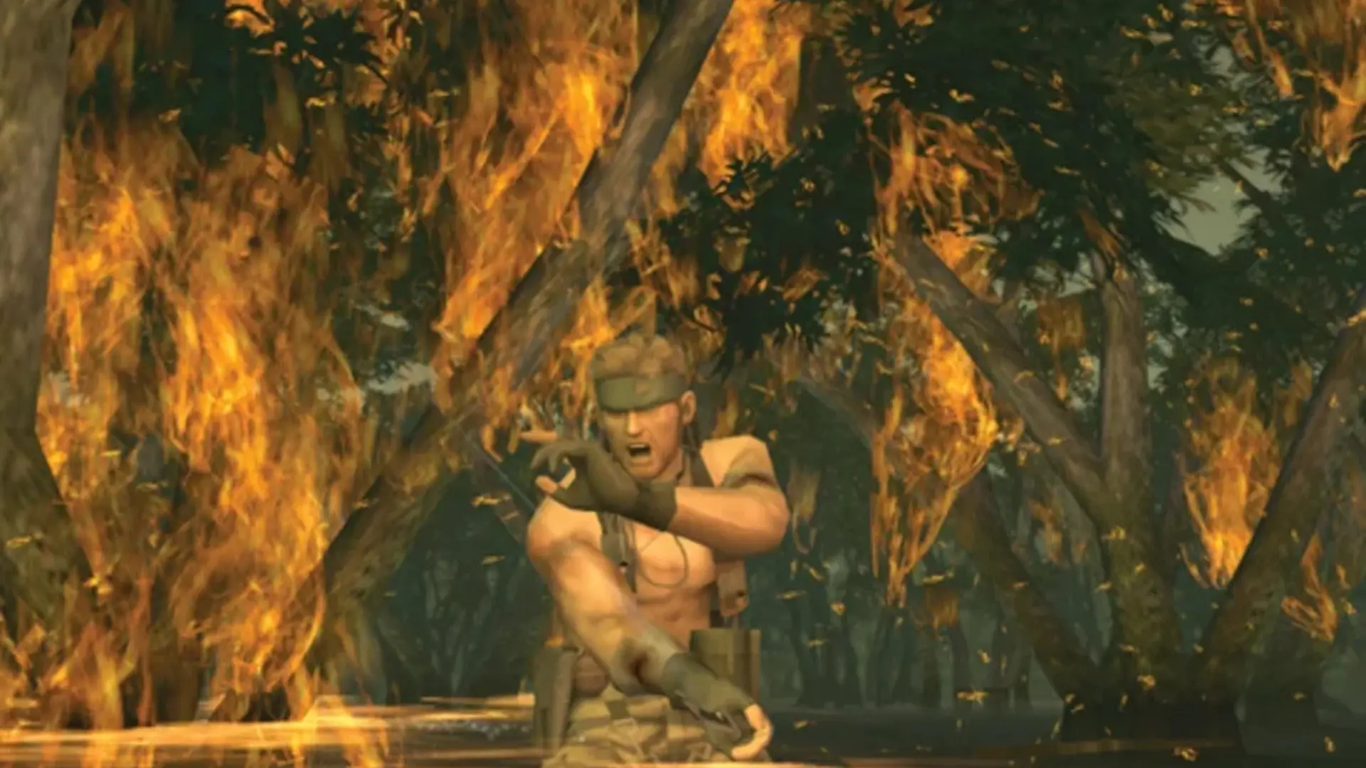 Naked Snake moves through burning vegetation during a mission in Metal Gear Solid 3: Snake Eater.