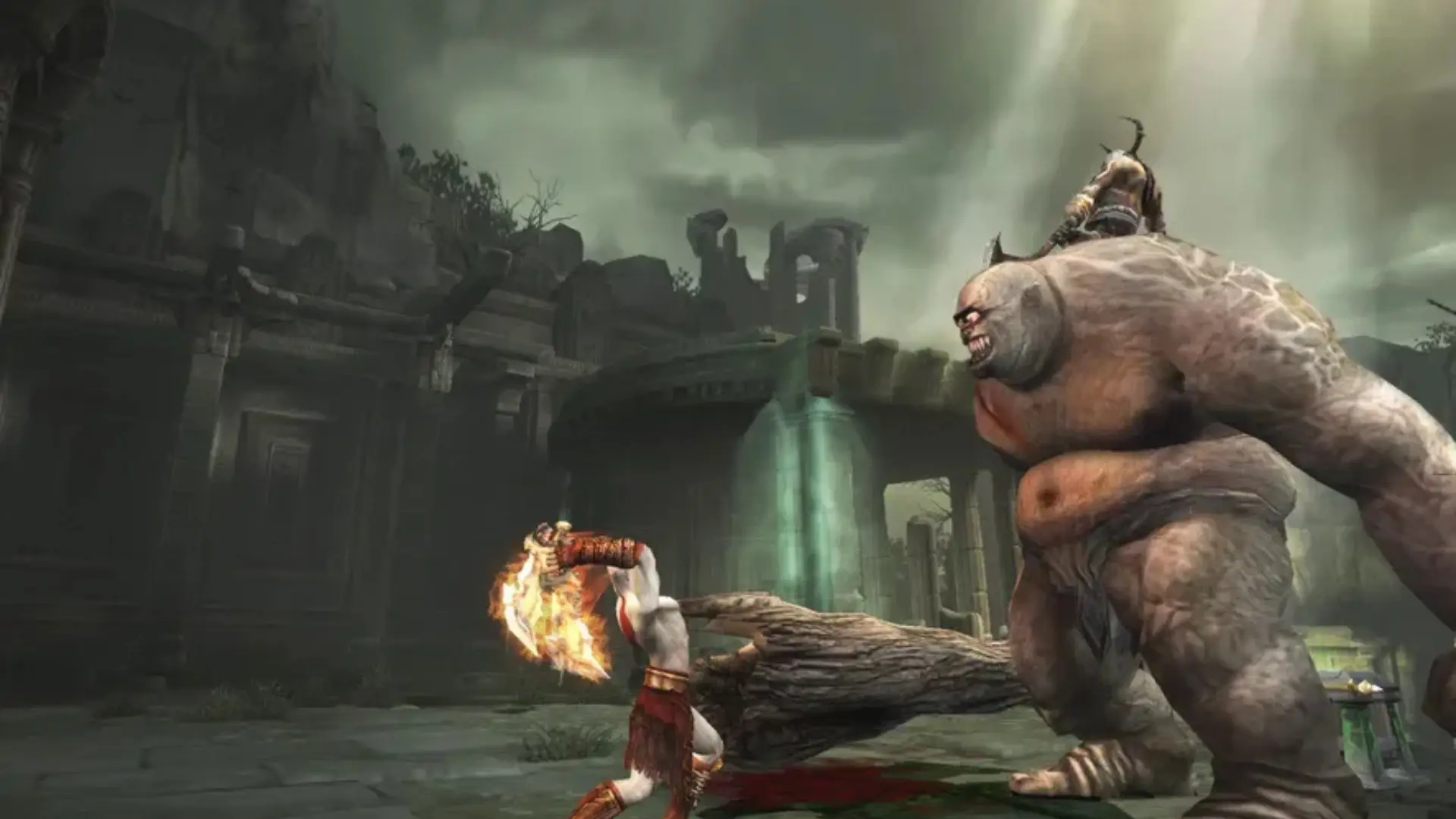 Kratos battles a giant enemy among ancient ruins in God of War II.