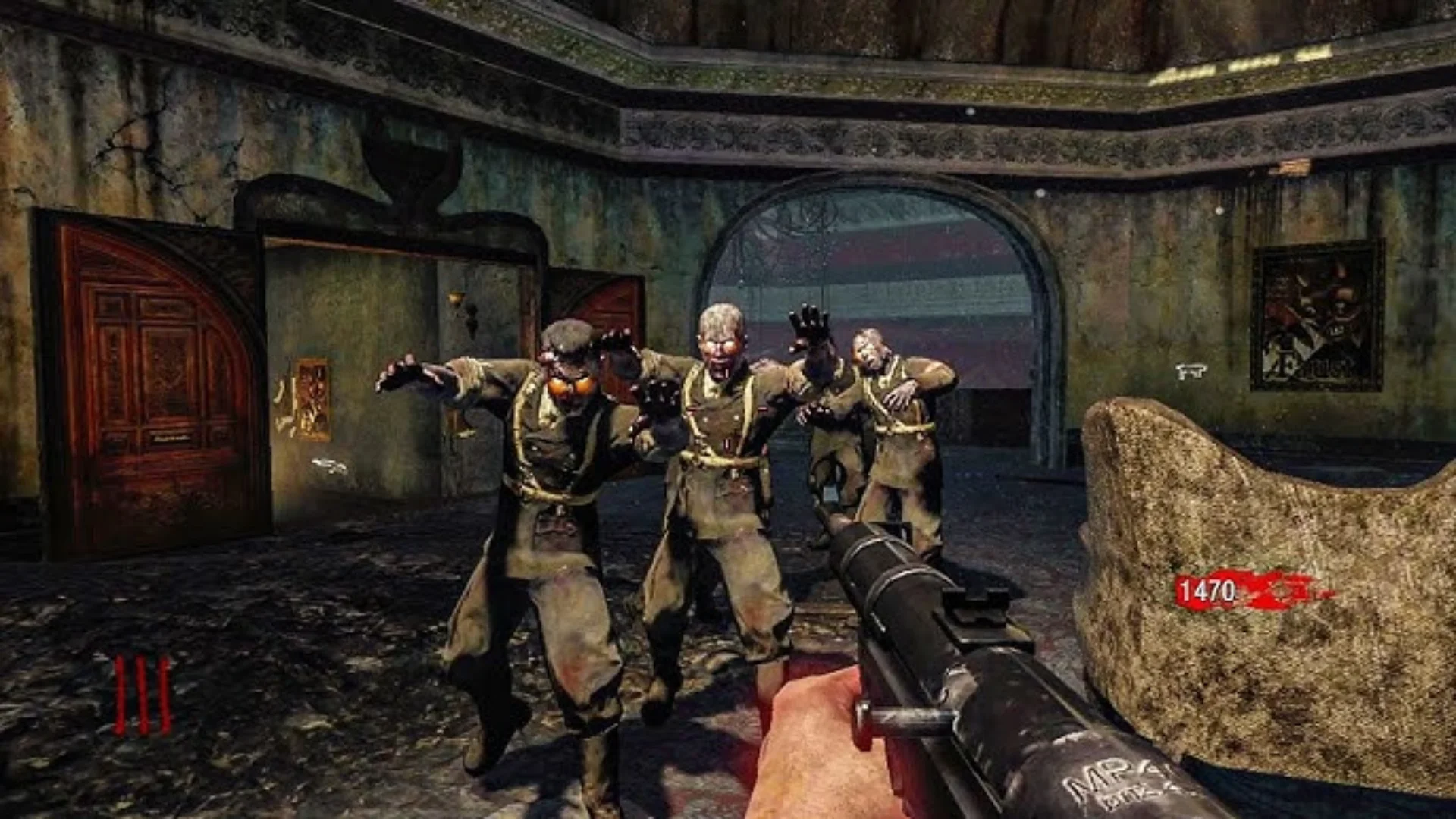Several zombies approach a player holding a shotgun inside a damaged theatre in Call of Duty: Black Ops.
