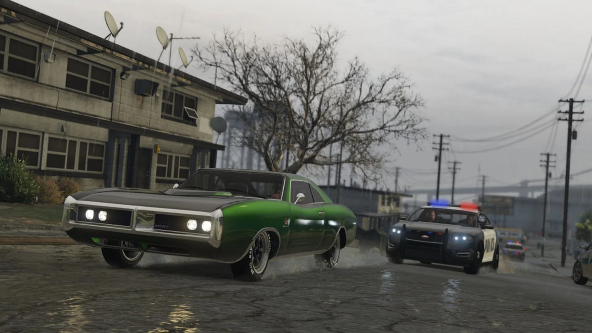 A green muscle car speeds along a wet road while police vehicles follow behind in GTA 6.