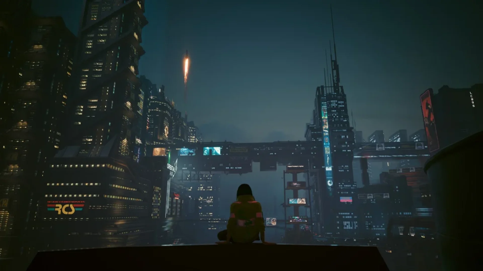 A character overlooks Night City as neon towers and advertisements light the skyline.