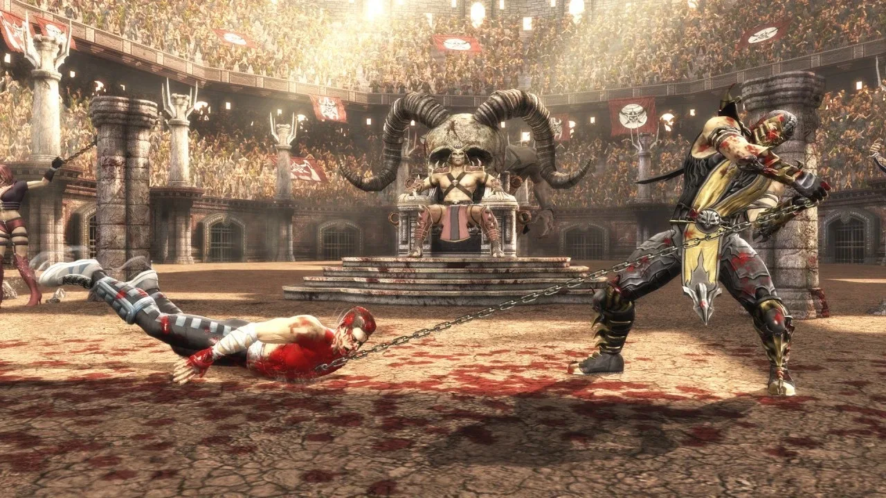 Scorpion uses his chained spear against a defeated opponent inside a crowded arena in Mortal Kombat.