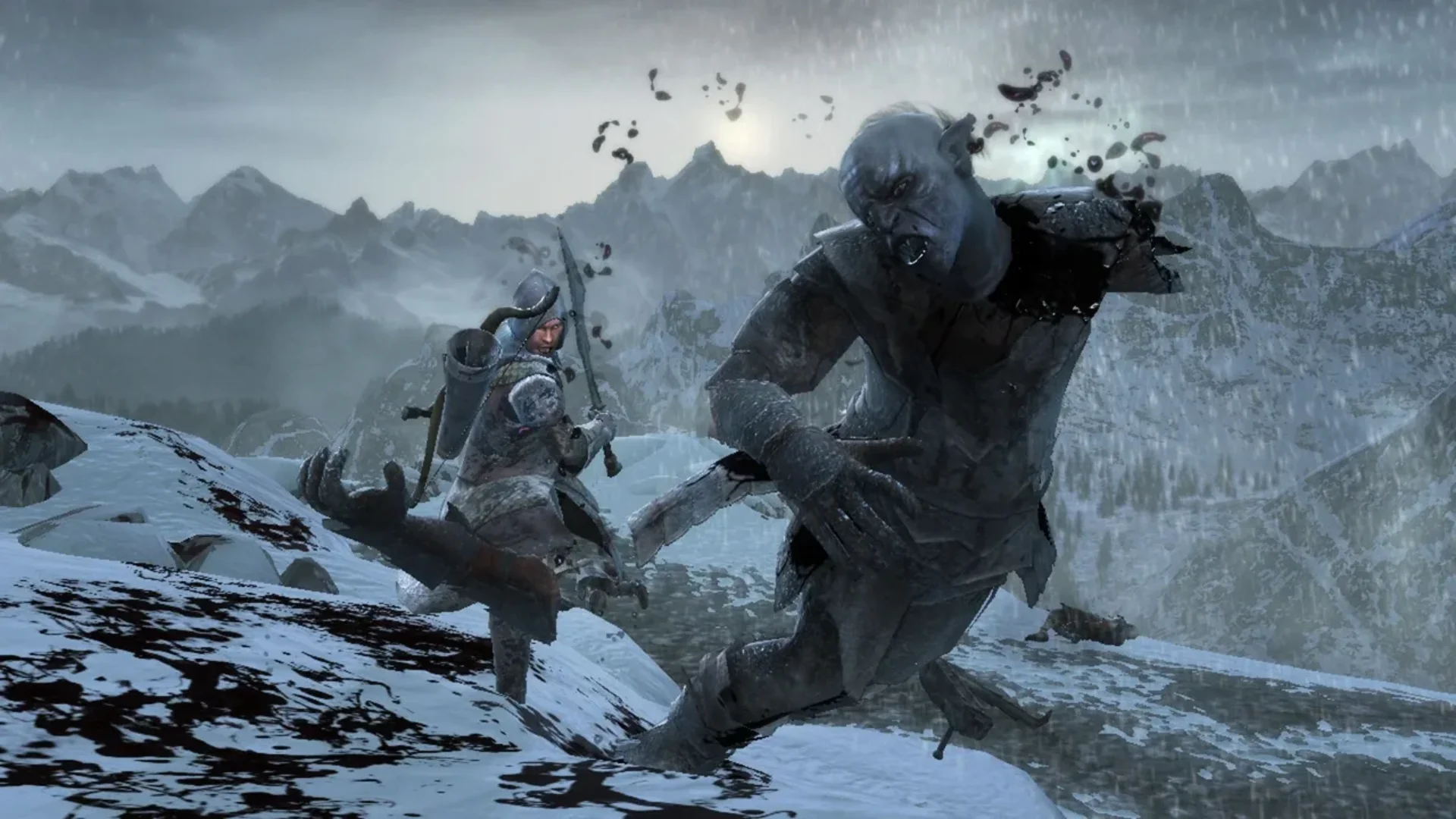 A warrior strikes a large troll during a snowy mountain battle in The Lord of the Rings: War in the North.