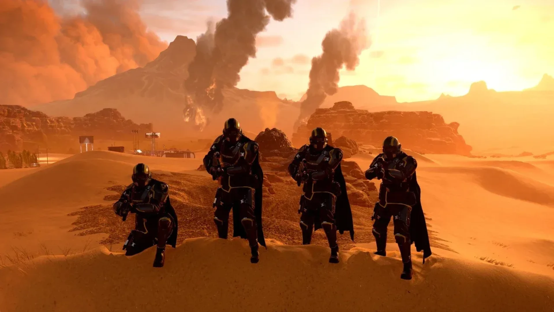 Four armoured Helldivers pose with weapons in an orange desert beneath smoke-filled skies.
