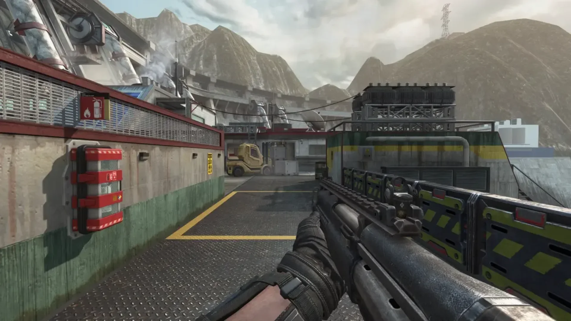 First-person gameplay on an industrial Black Ops II multiplayer map with a rifle aimed down a walkway.