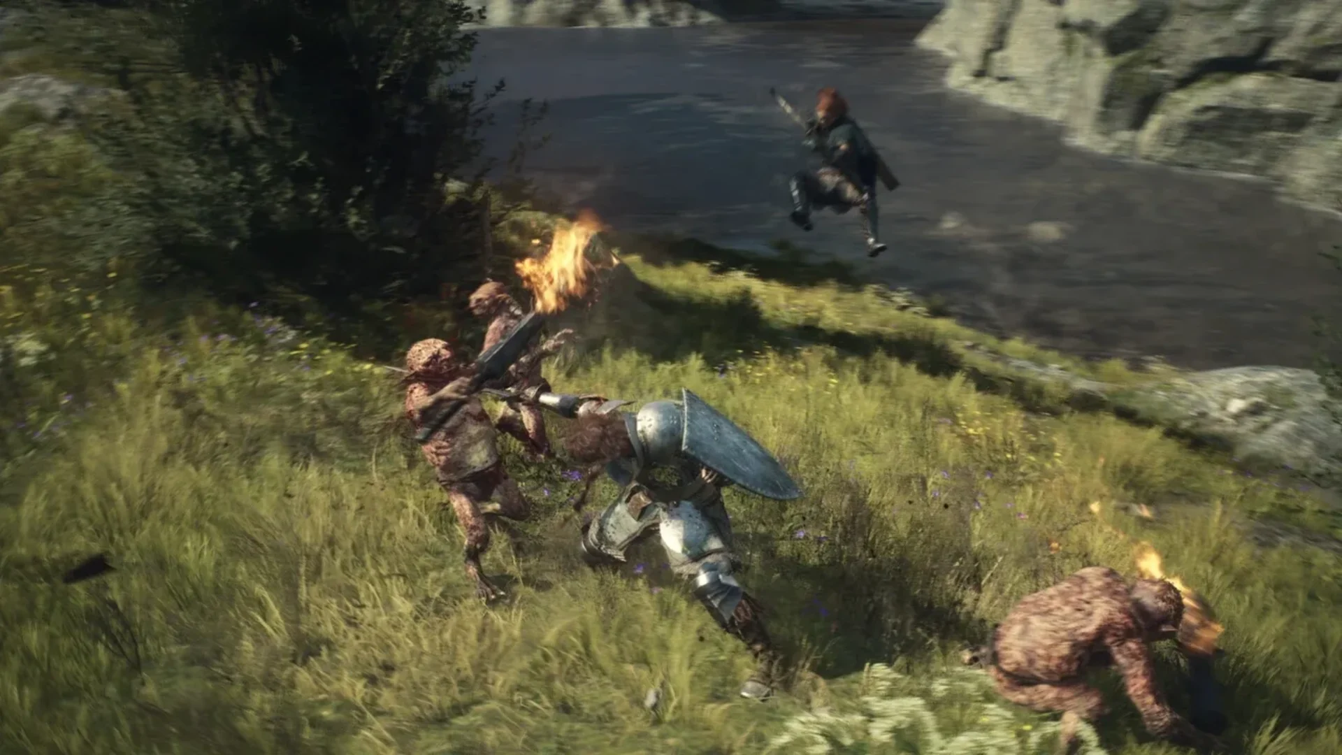 An armoured fighter battles goblin-like enemies beside a river in Dragon’s Dogma 2.