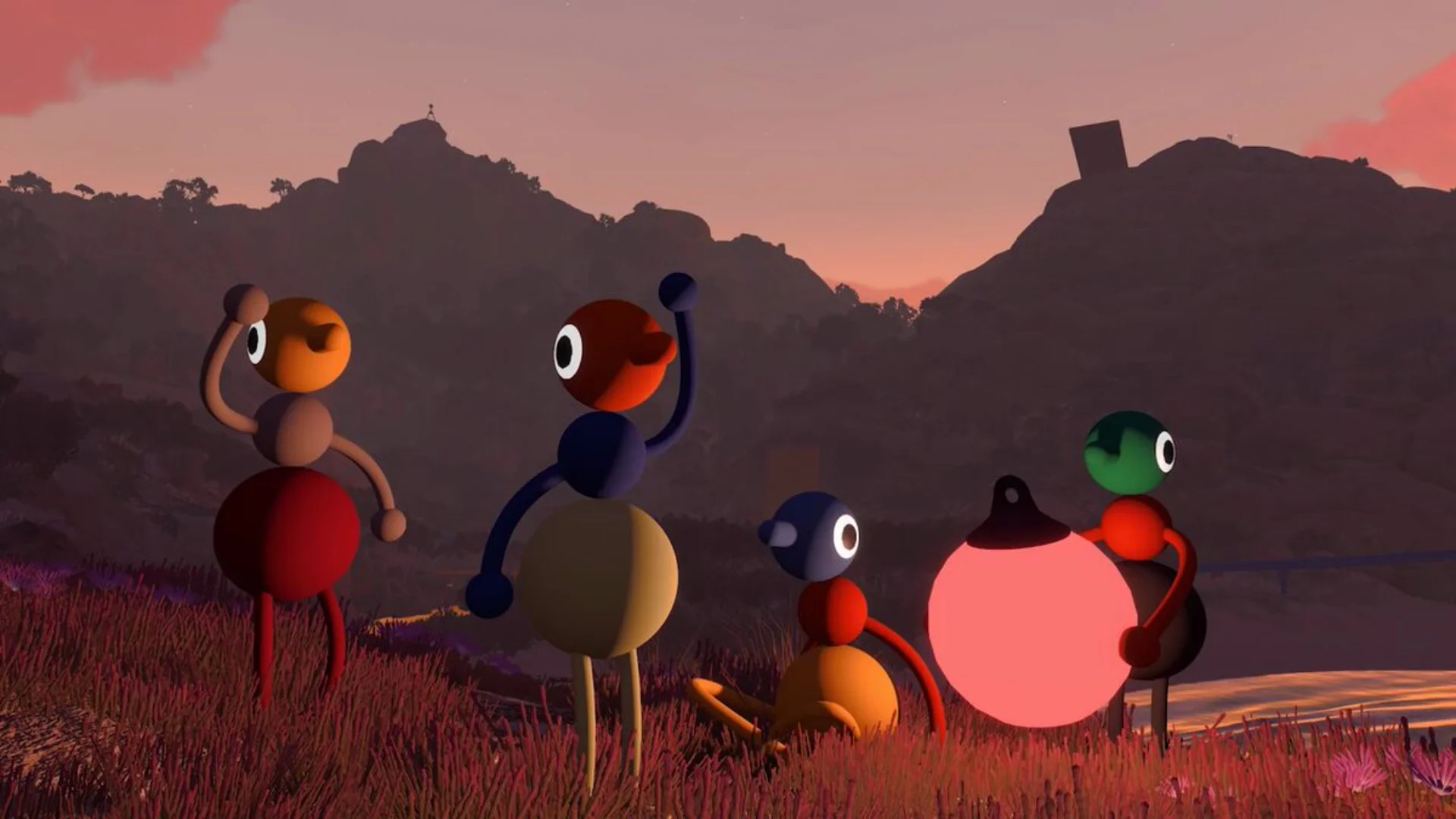 Five colourful Big Walk characters stand together beside a glowing lantern in a mountainous landscape at sunset.