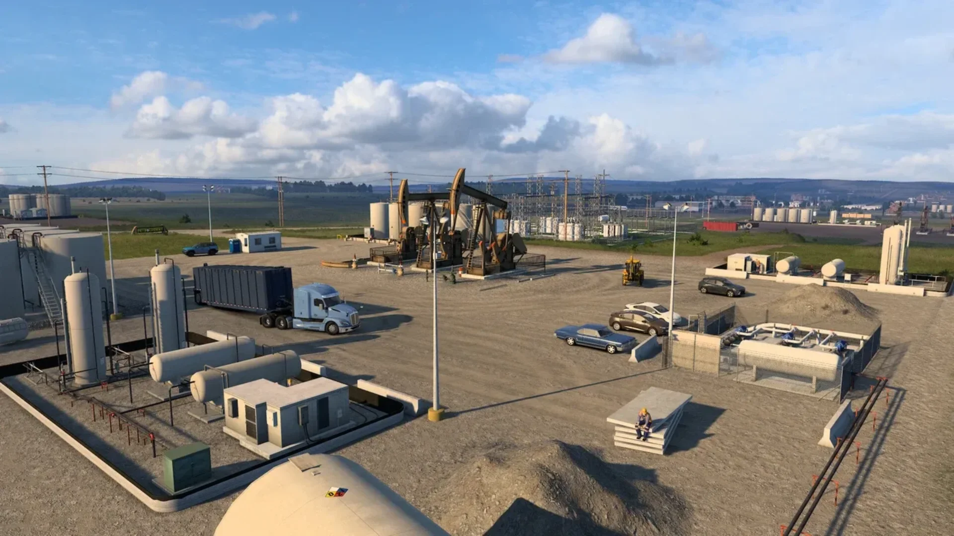 Trucks and vehicles move through a North Dakota oil facility with pumpjacks, storage tanks, and industrial equipment.