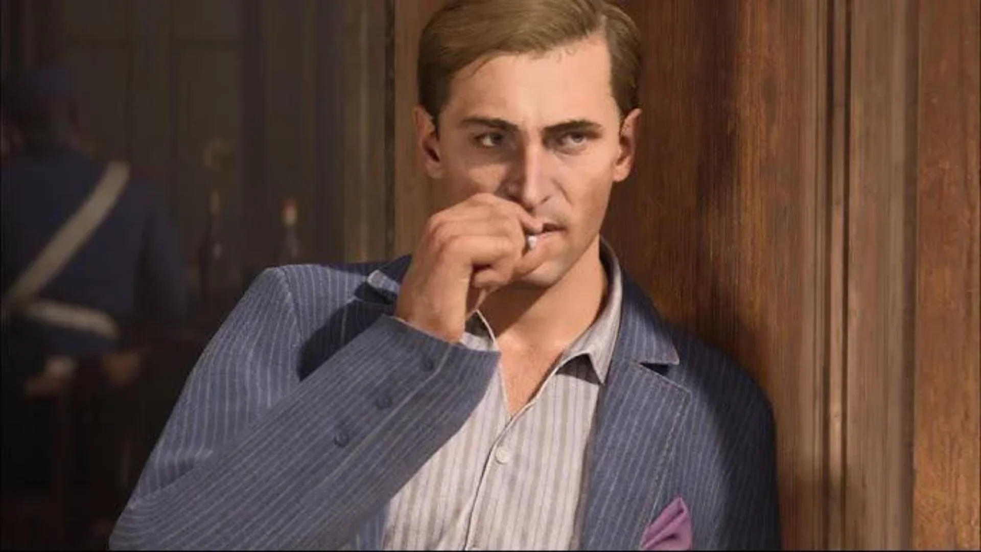 A young Ennio Salieri wears a blue pinstripe suit while sitting inside a wooden room.