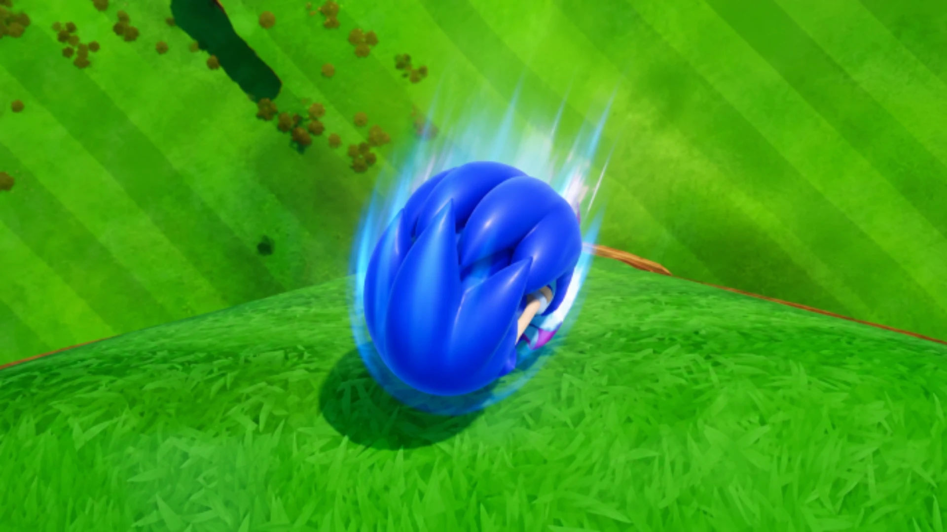 Sonic curls into a blue Spin Dash while speeding down a grassy Green Hill Zone slope.