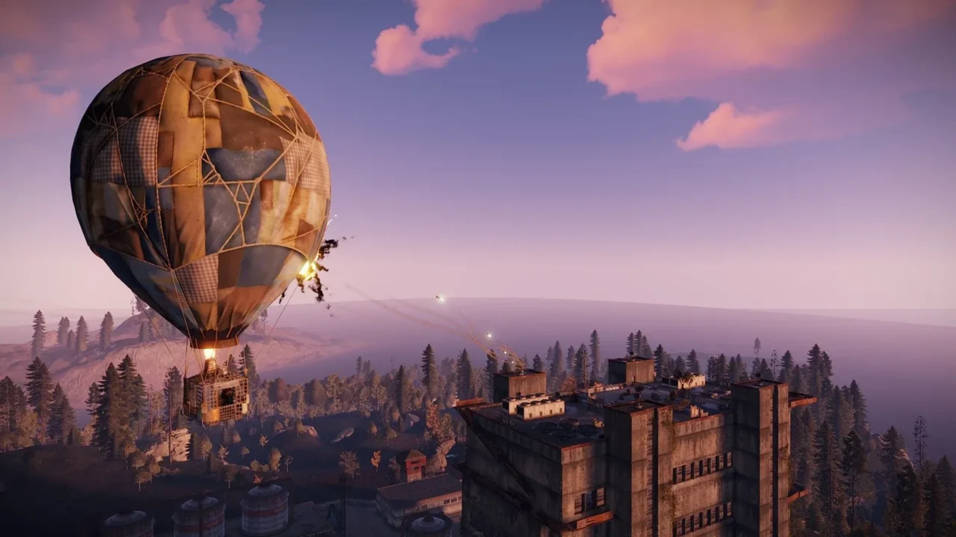A hot air balloon flies beside an industrial building at sunset in Rust