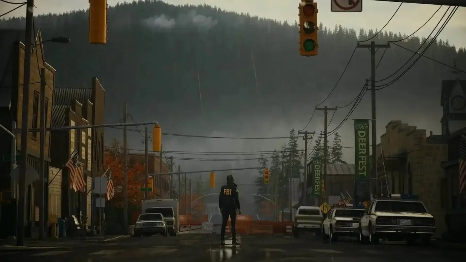 An FBI agent stands in the rain on a deserted street in Bright Falls in Alan Wake 2.