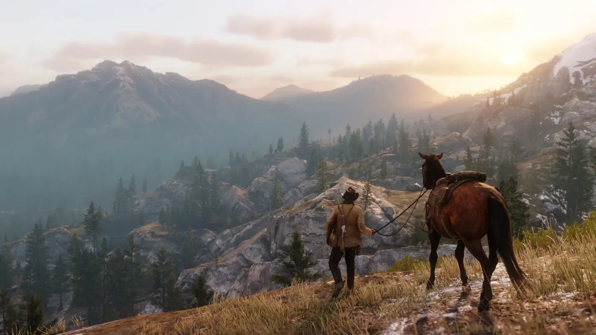 Arthur Morgan stands beside his horse overlooking a mountain valley in Red Dead Redemption 2.