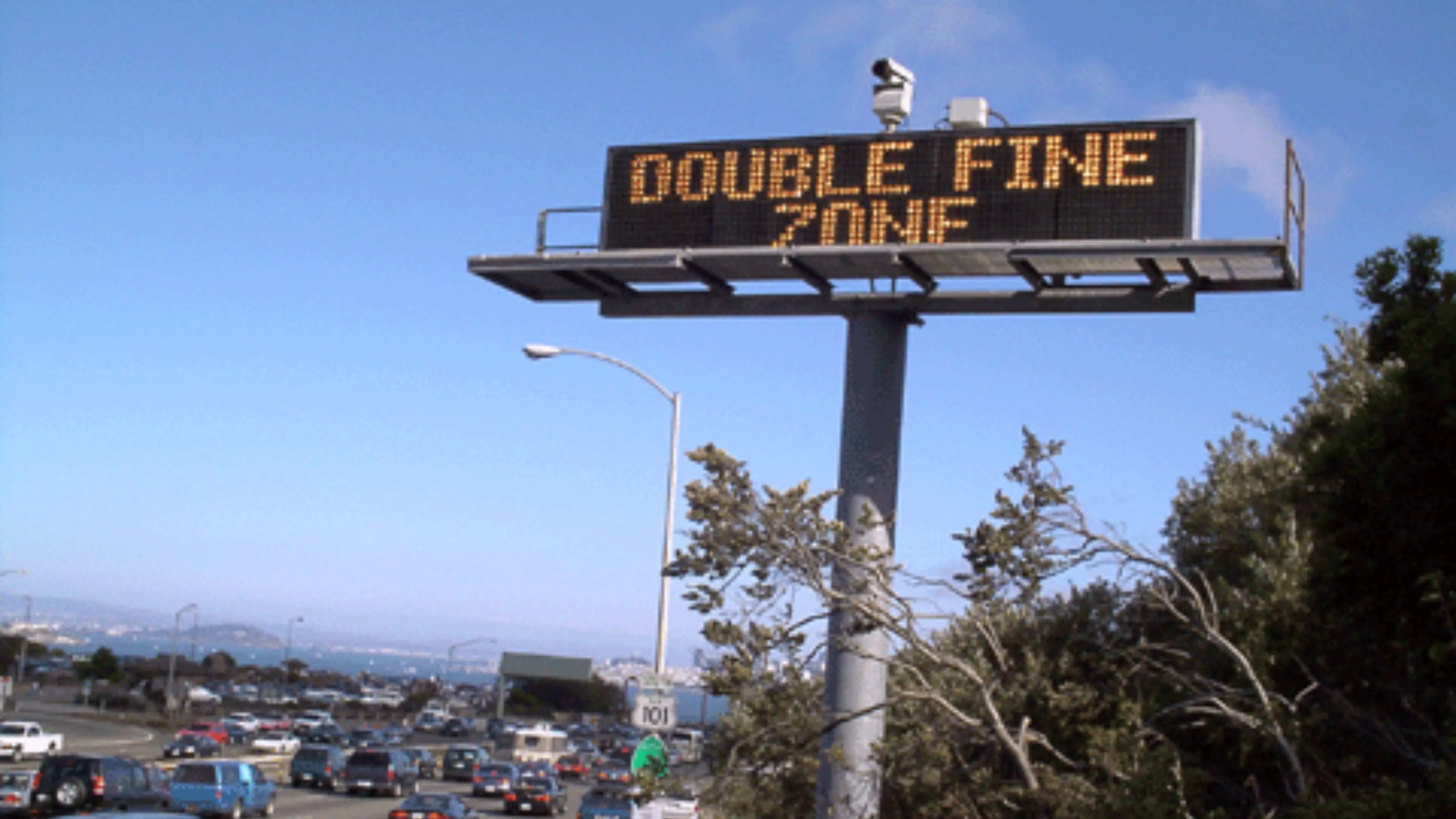 Highway sign displaying the words Double Fine Zone