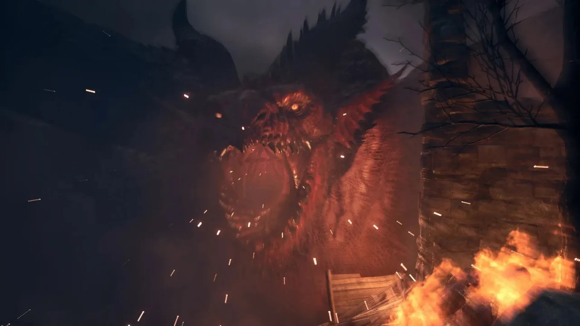 The Fallen Dragon roars from a burning ruin in Dragon's Dogma 2: Dark Arisen.