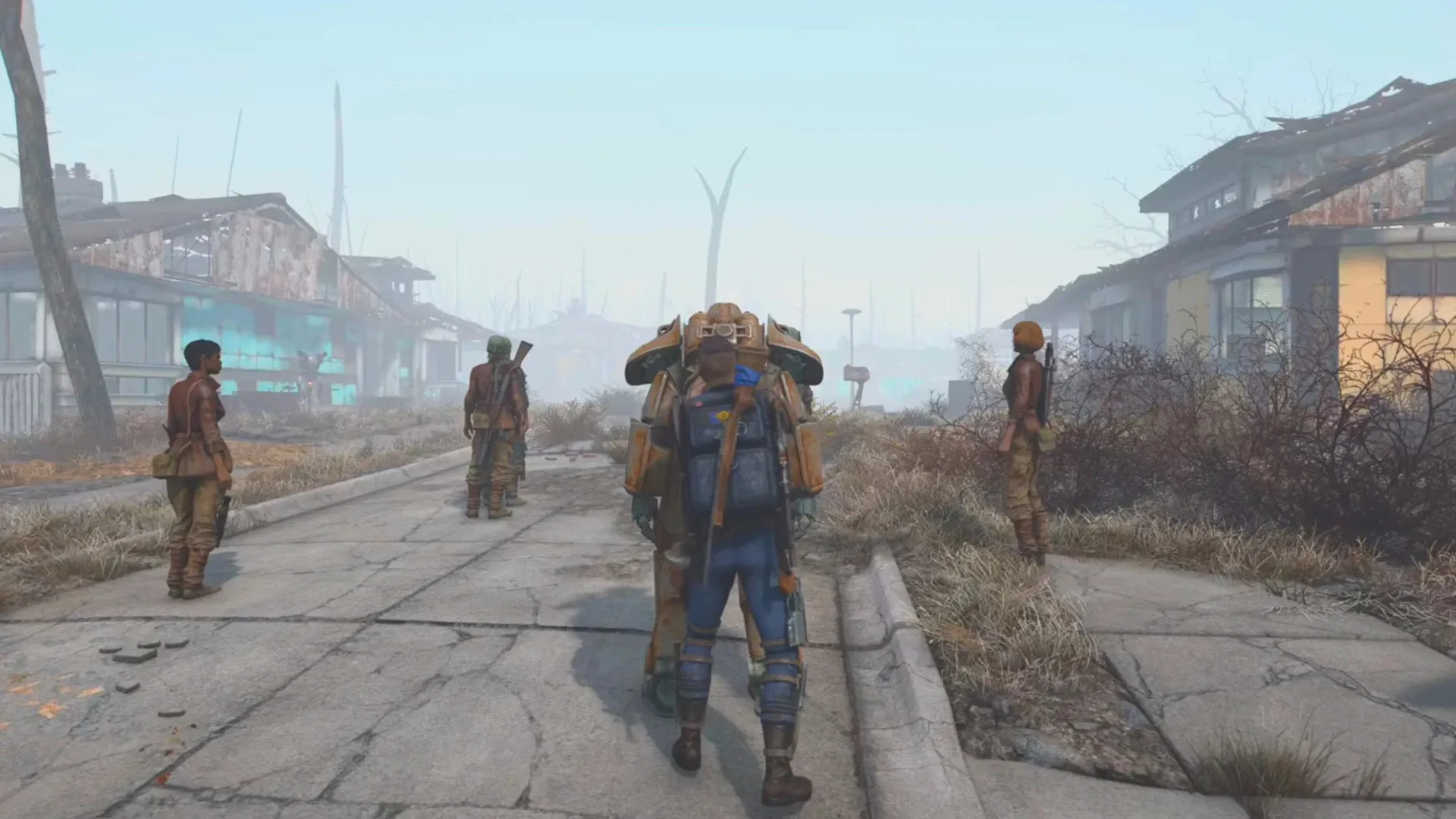 Fallout 4 character in power armor walking through a ruined settlement with companions