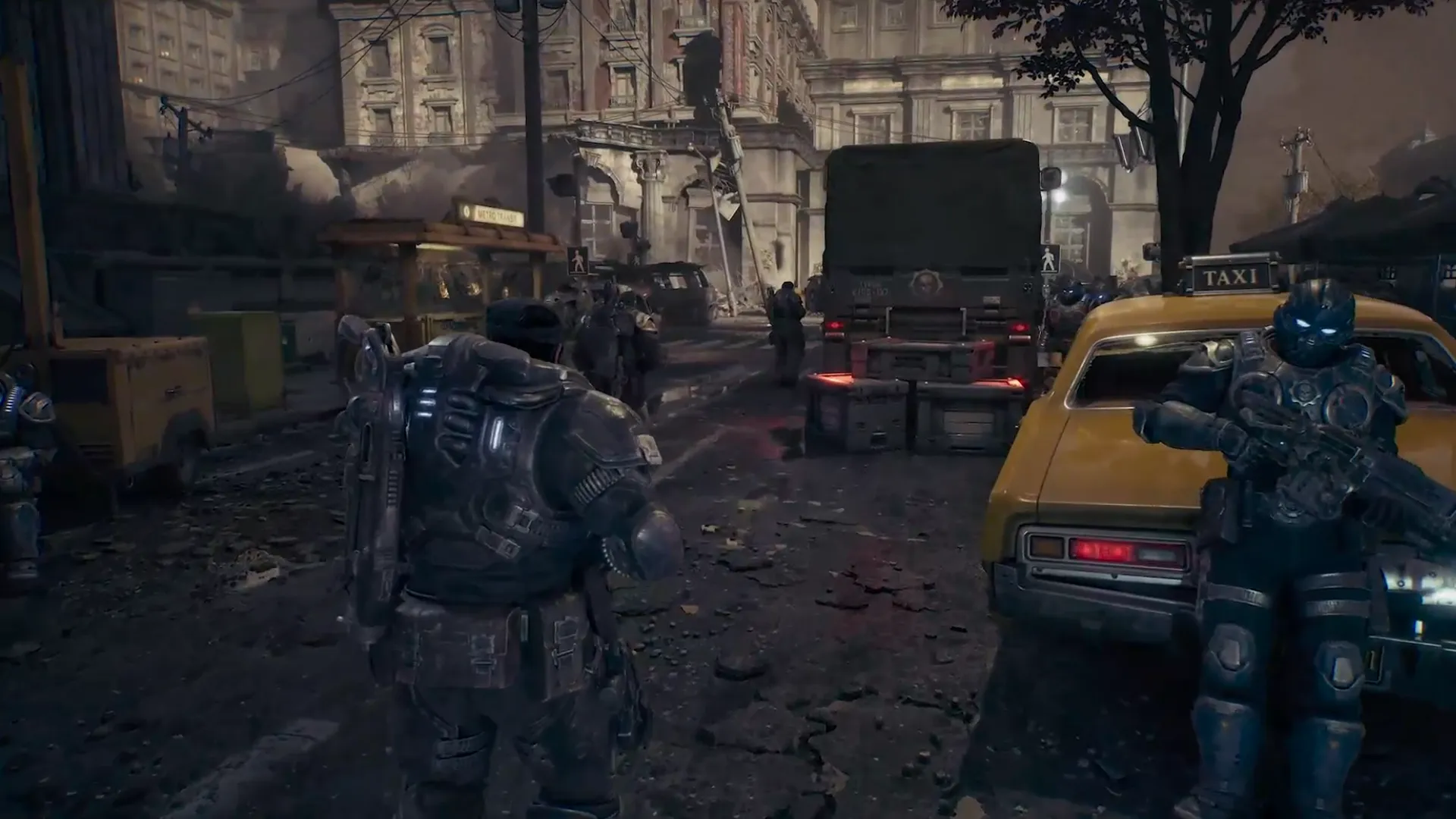 Gears soldiers move through a damaged Kalona street beside a yellow taxi in Gears of War: E-Day.