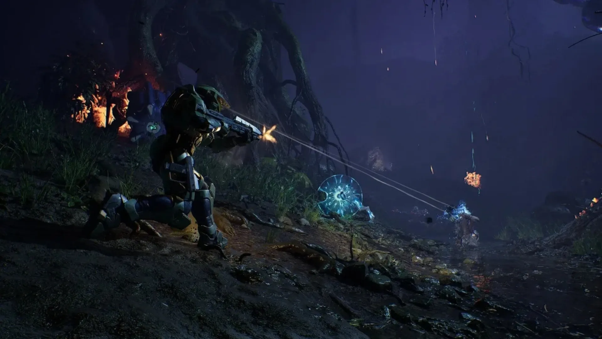 Armored Spartan standing inside a dark alien environment in Halo