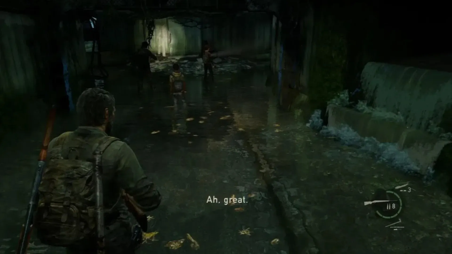 Joel holds a shotgun while moving through a flooded tunnel in The Last of Us.
