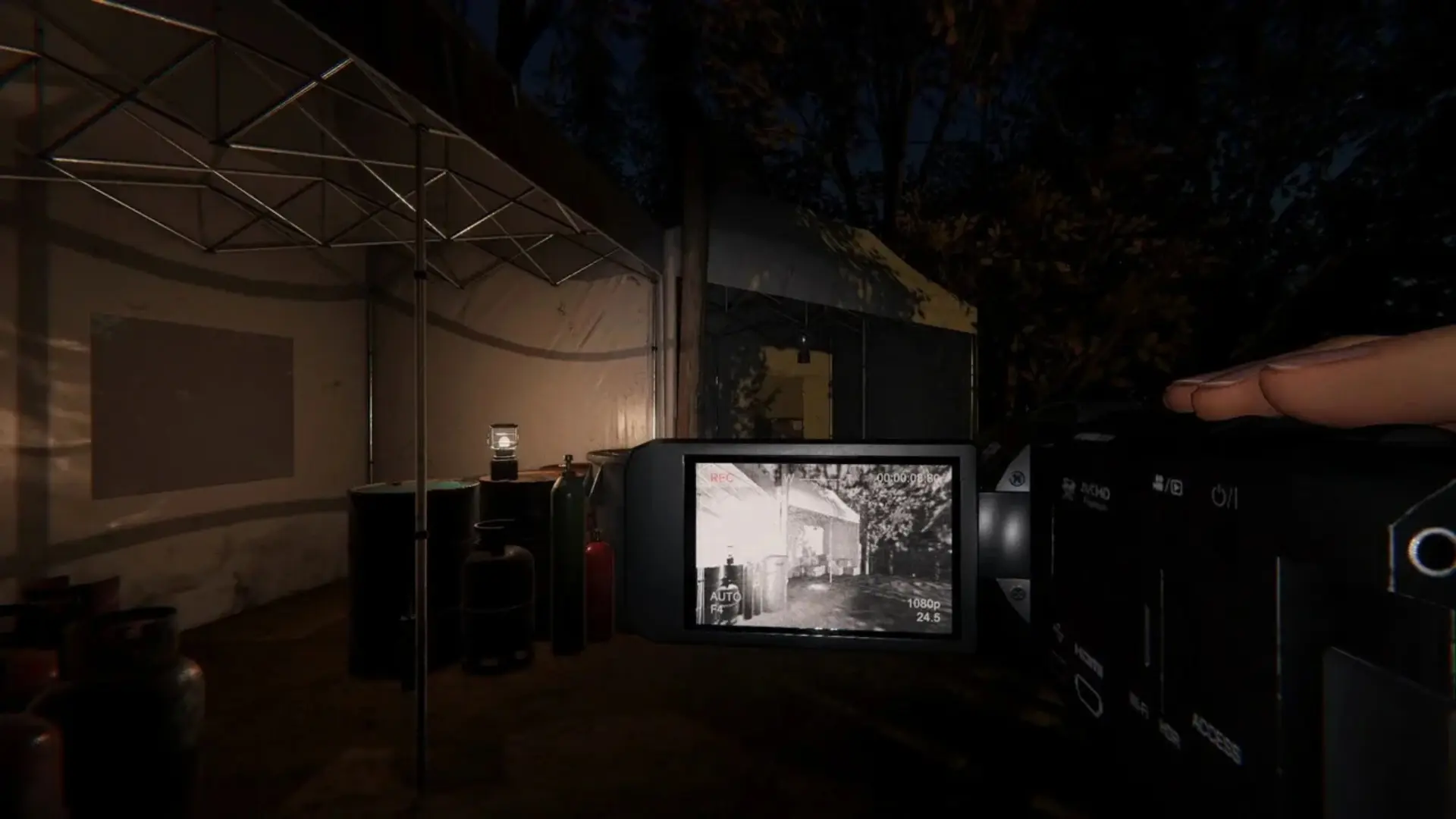 A player checks a video camera display while investigating a dark outdoor location in Phasmophobia.