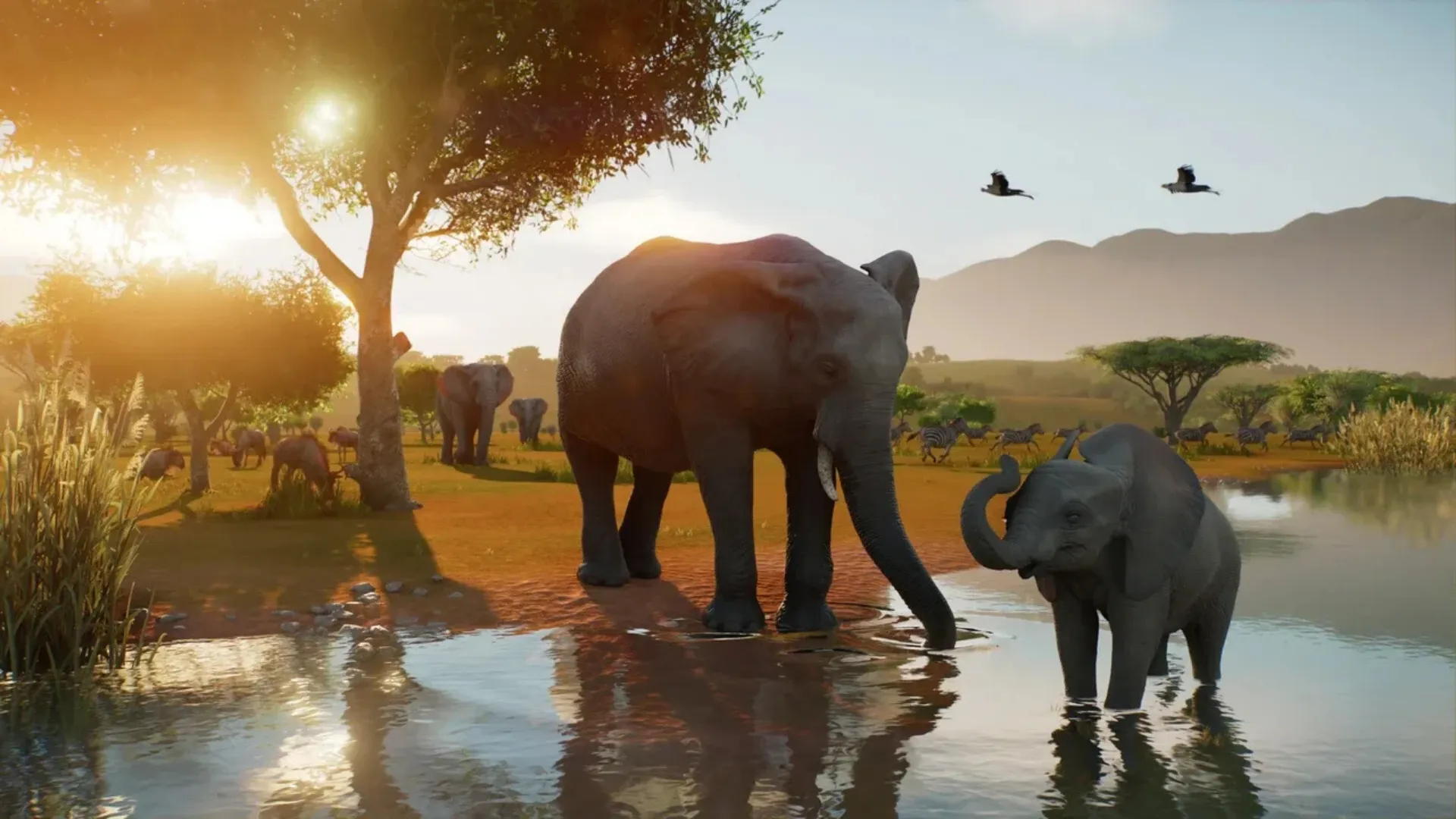 Adult and young elephants stand in a watering hole surrounded by wildlife in Planet Zoo 2.
