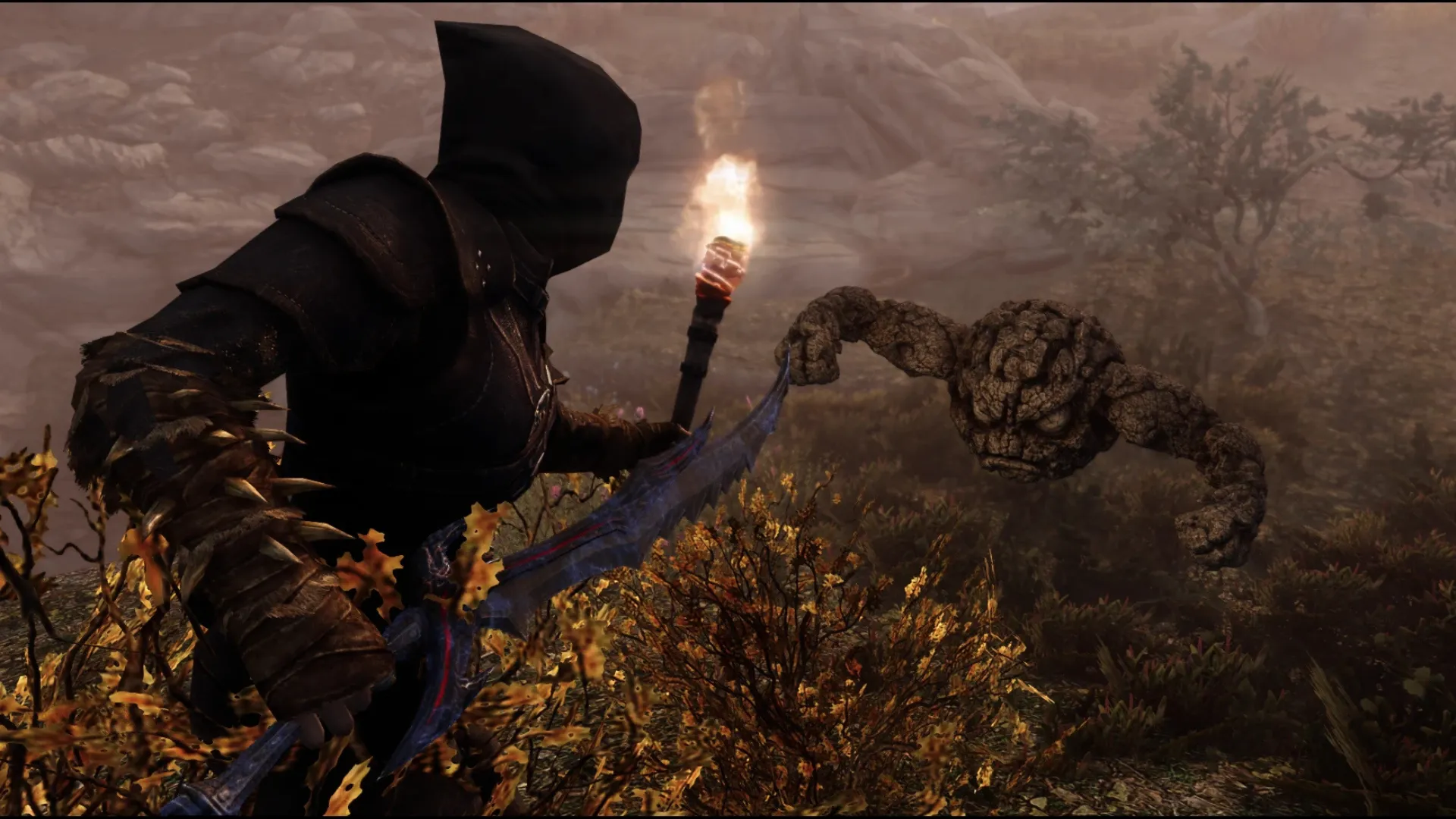 Skyrim character holding a torch while facing a rocky creature in the wilderness