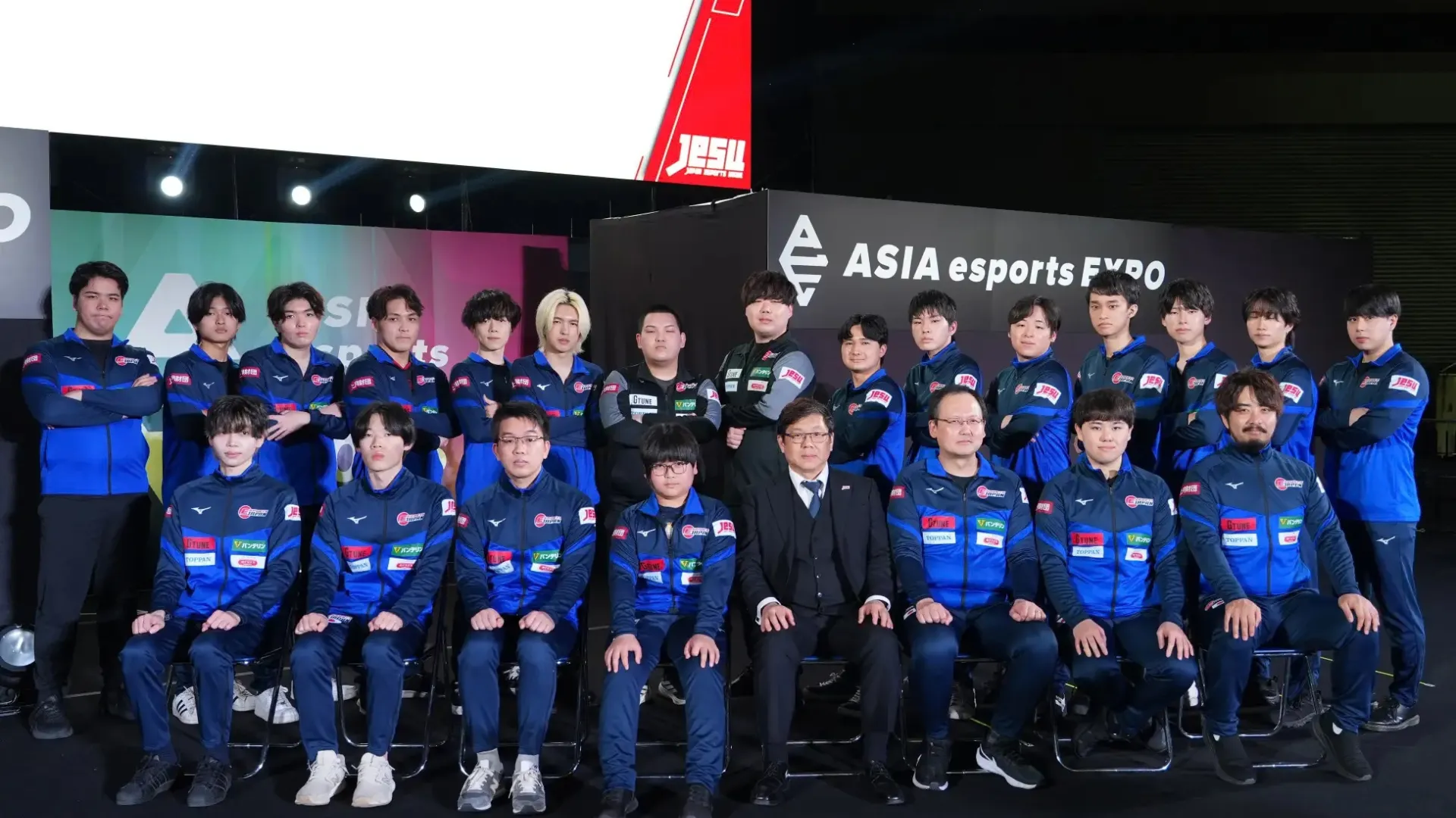 Japan's Asian Games esports squad poses together in blue uniforms at ASIA Esports EXPO 2026