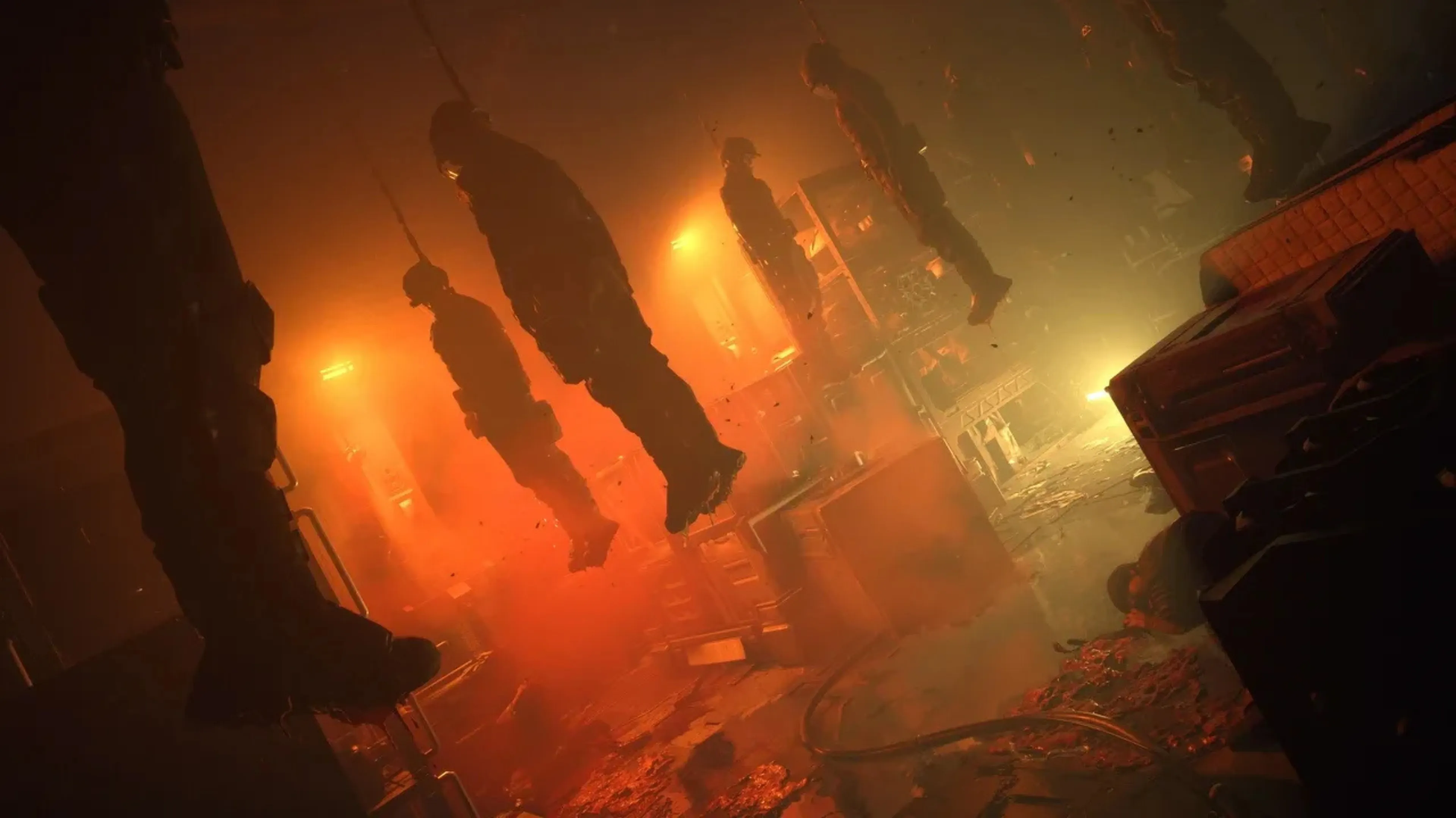 Bodies hang inside an orange-lit corridor in Black Iron Prison