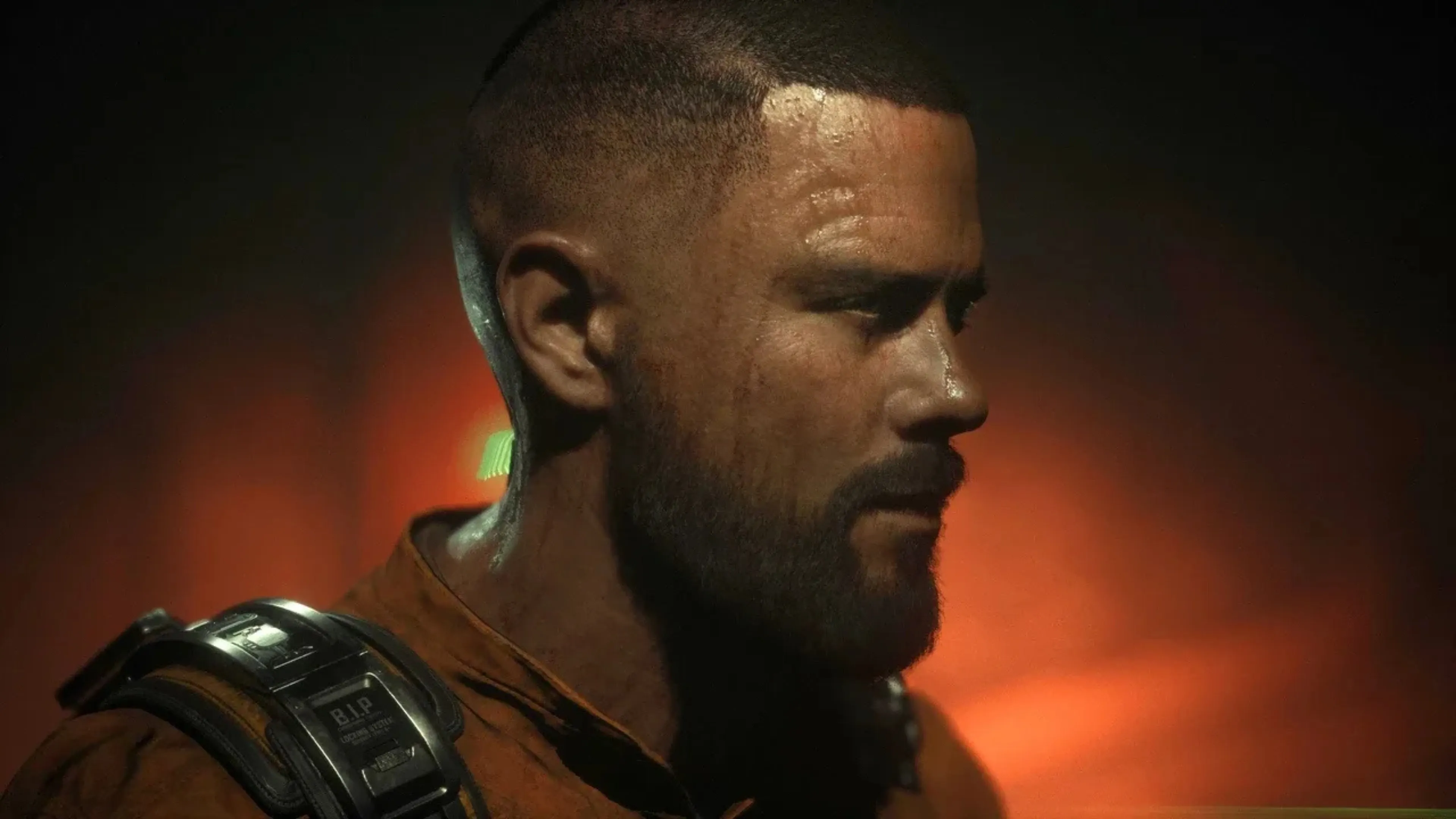 Jacob Lee in a close-up scene from The Callisto ProtocolJacob Lee appears in an orange Black Iron Prison uniform during a clo