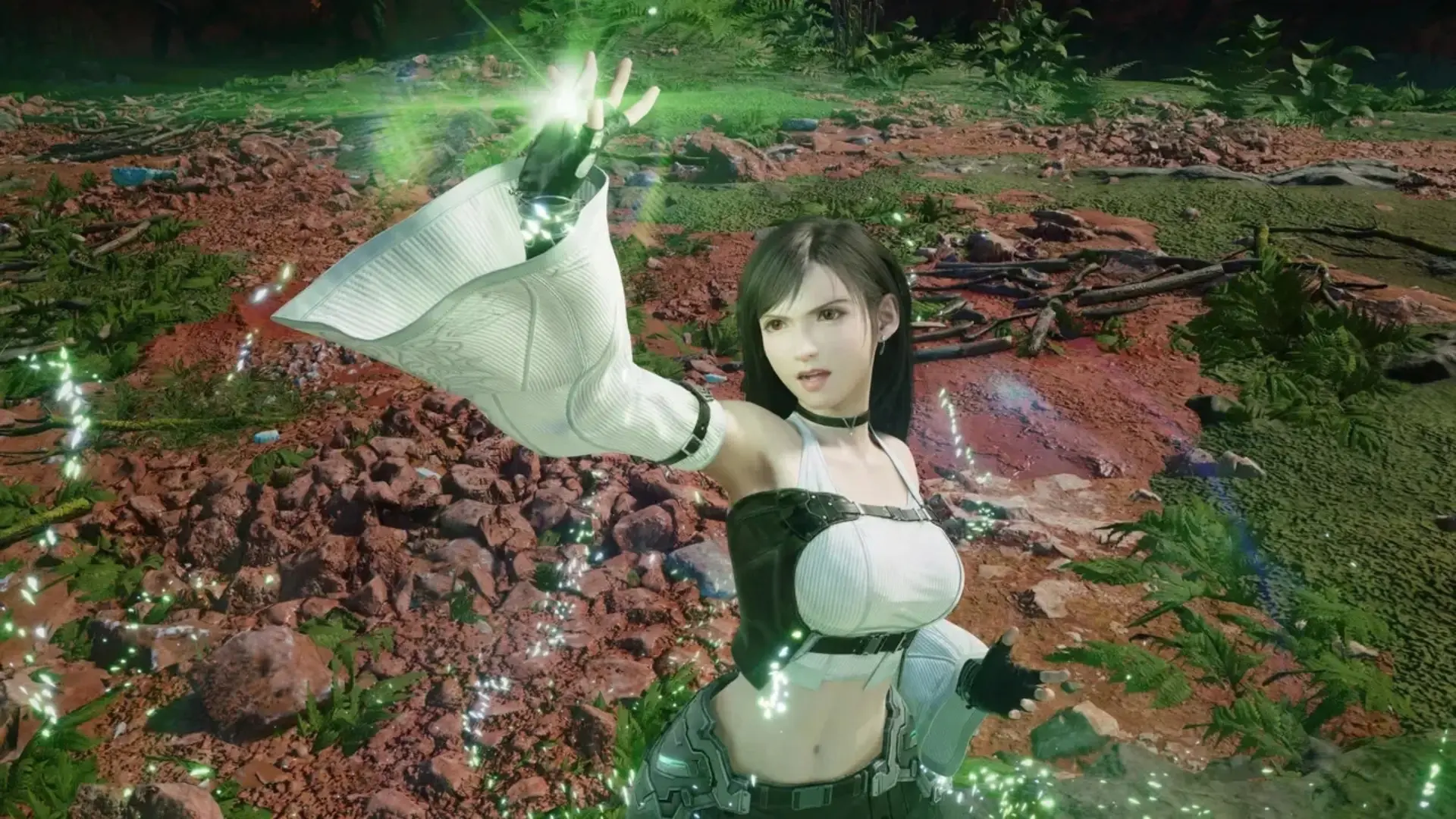 Tifa Lockhart raises a glowing hand in an outdoor scene from Final Fantasy VII Revelation