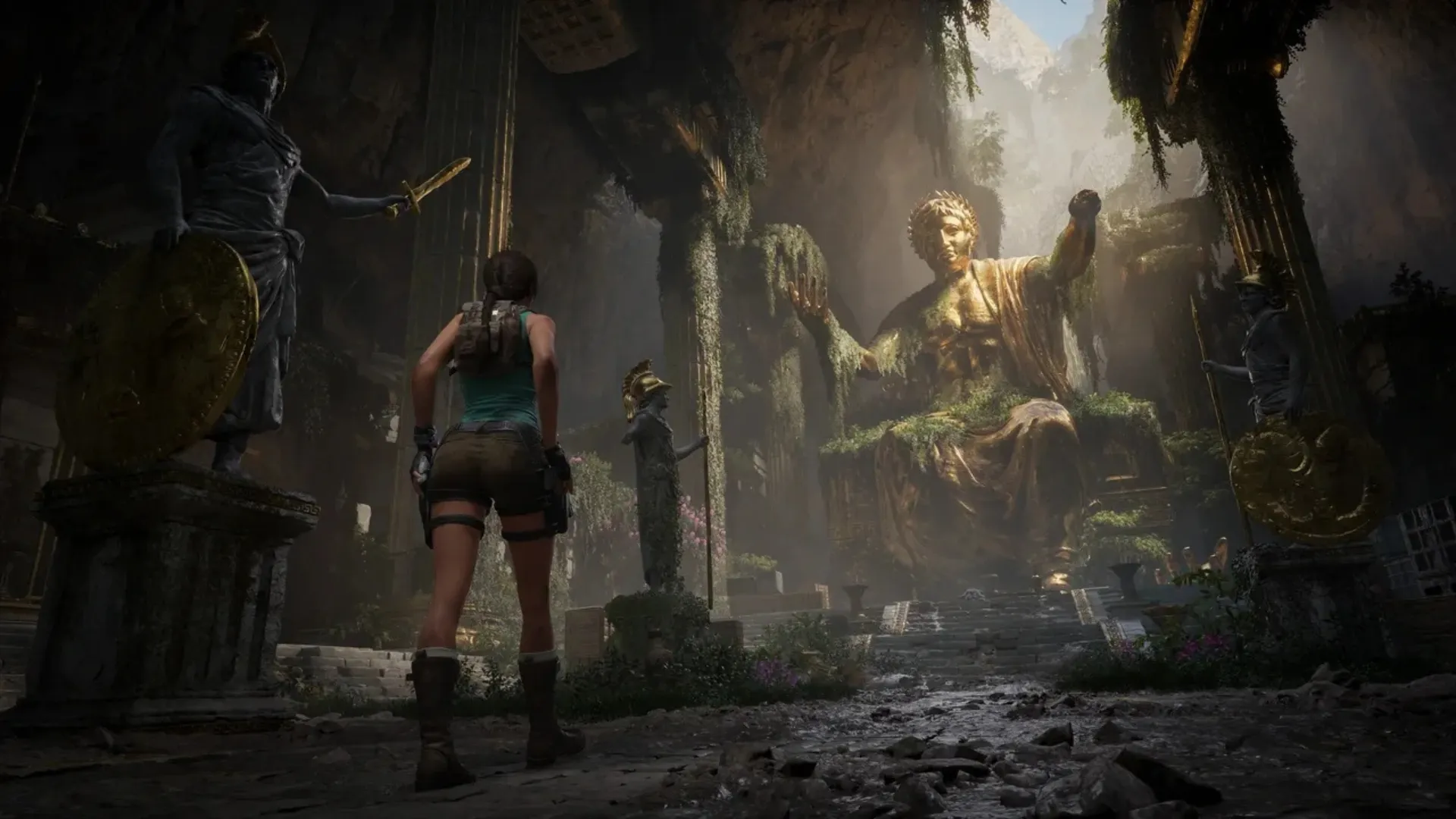 Lara Croft faces a huge seated statue inside overgrown ancient ruins in Tomb Raider: Legacy of Atlantis.