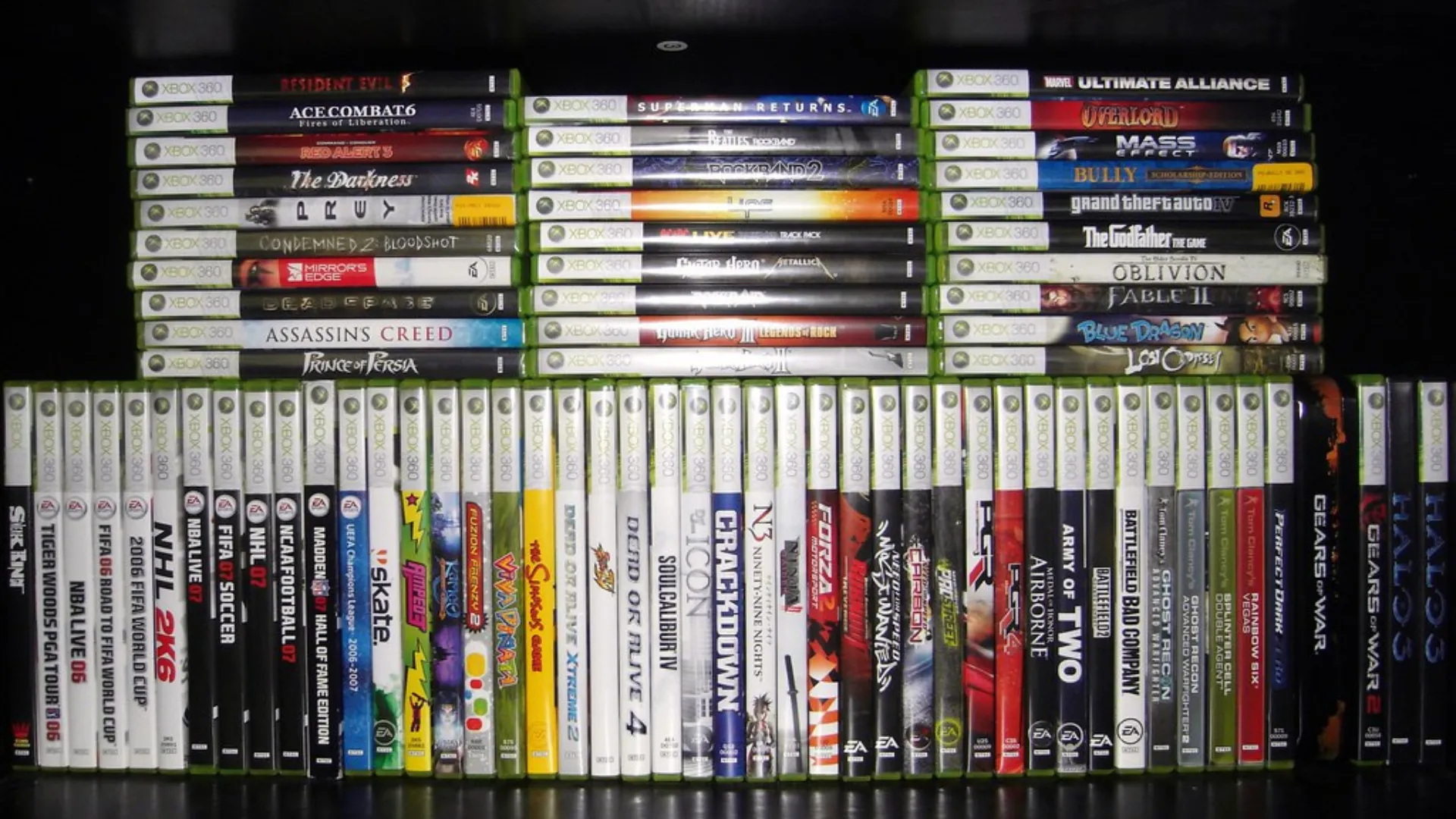 A large collection of physical Xbox 360 game cases arranged in rows on a shelf.