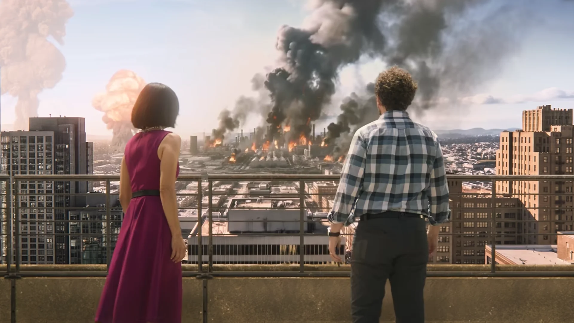 Two people watch smoke and explosions spread across Central Usea during the Ace Combat 8 HOUR ZERO prequel.