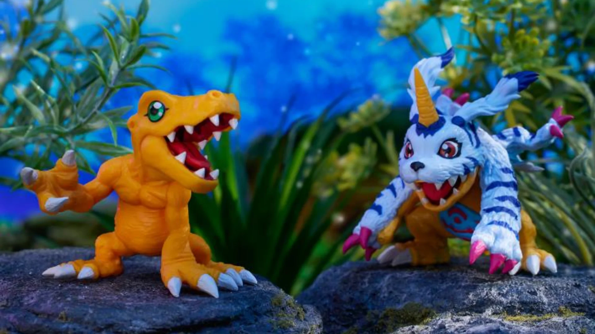 Agumon and Gabumon face each other in a colorful outdoor scene from the Digimon Adventure crossover.