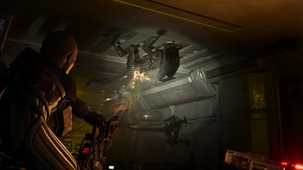 A marine fires at Xenomorphs crawling across the walls and ceiling in Aliens: Fireteam Elite 2.