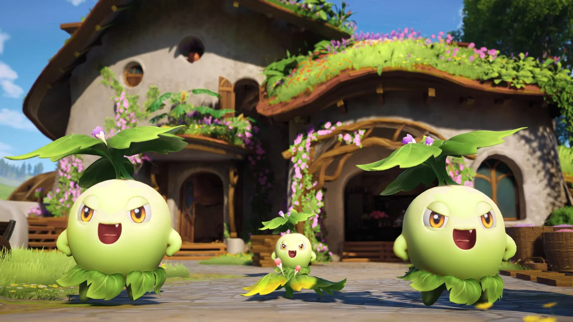 Three green Aniimo creatures stand outside a flower-covered house under a bright blue sky.
