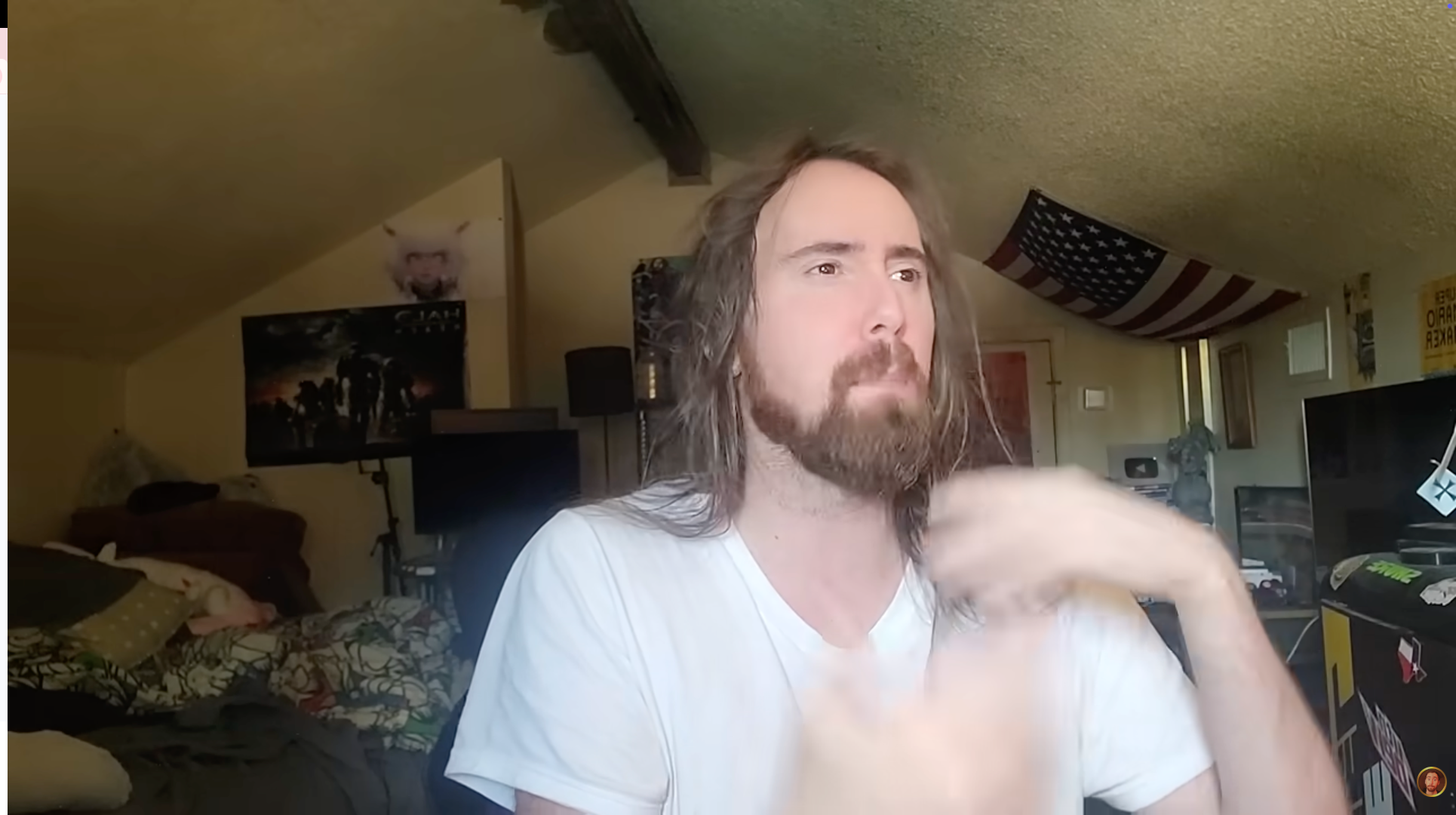 Asmongold speaking to the camera from his streaming setup at home.