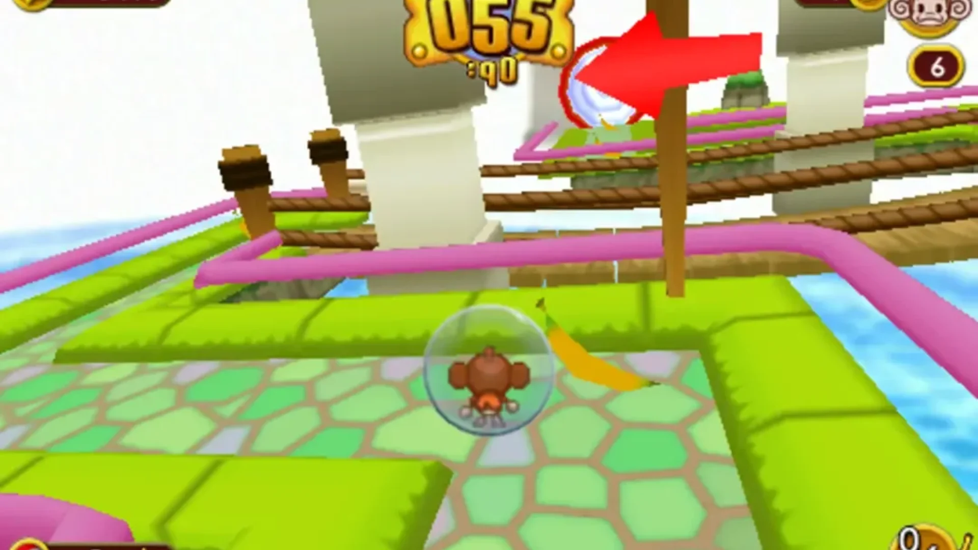 A monkey rolls inside a transparent ball across a colorful elevated course in Super Monkey Ball.